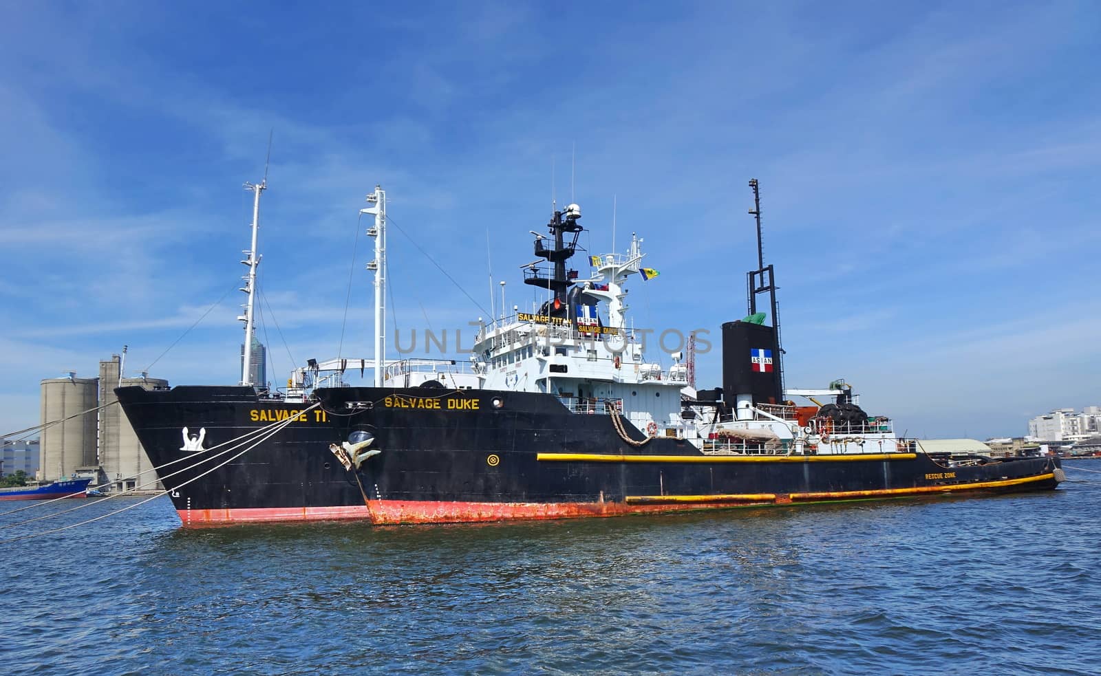 KAOHSIUNG, TAIWAN -- MAY 26, 2018: Two large ocean-going tugs are anchored in the busy port of Kaohsiung, a major trading hub for Taiwan.