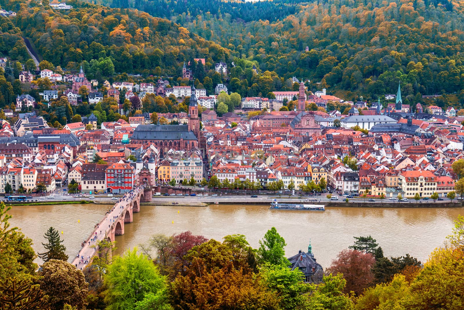 View on Heidelberg in autumn with red foliage including Carl Theodor Old Bridge, Neckar river, Church of the Holy Spirit, Germany