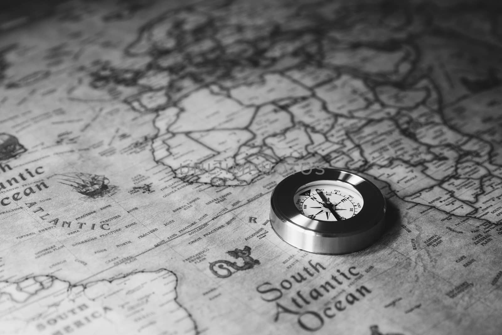 Old vintage retro golden compass on ancient map. Selective focus, shallow depth of field. Concept of world travel, sightseeing and tourism.