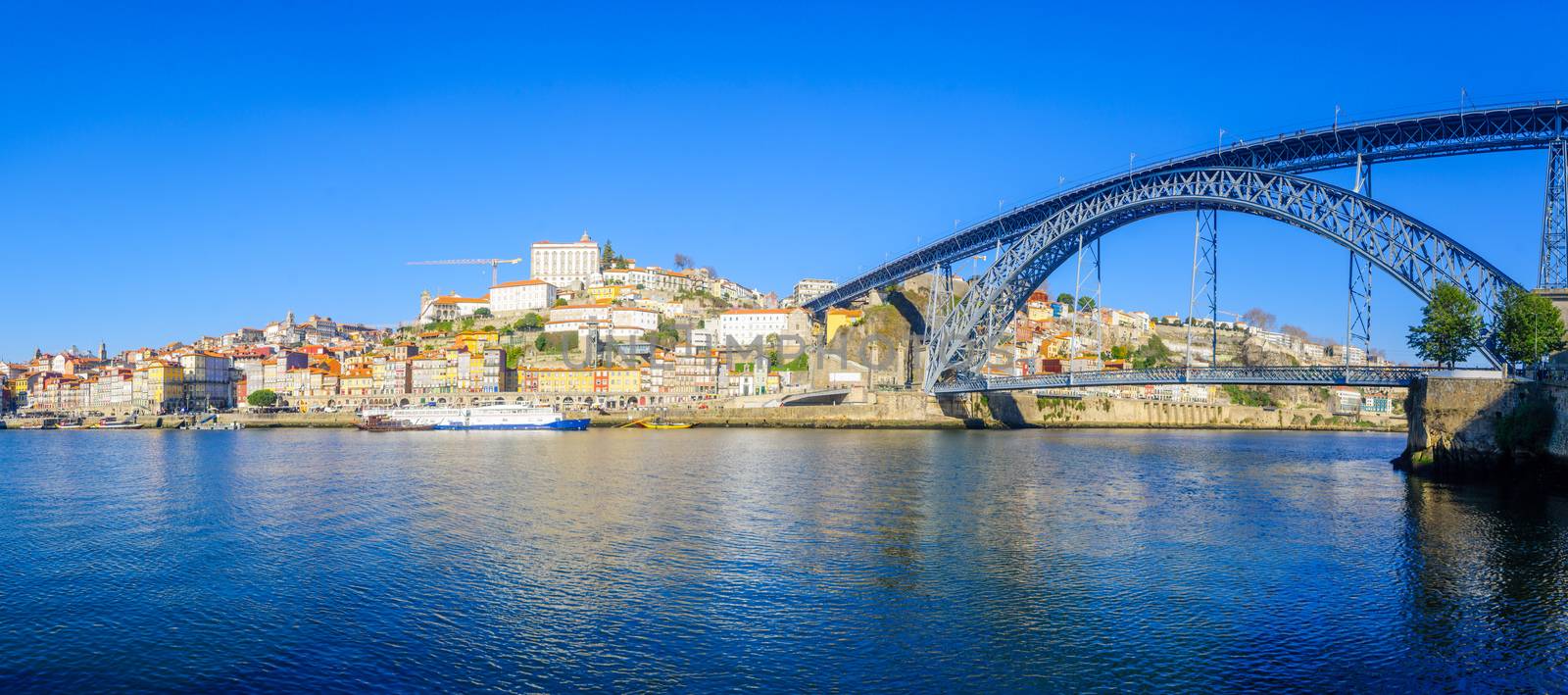 Panoramic view of the Dom Luis I Bridge, the Douro river and the Ribeira (riverside), with colorful buildings, in Porto, Portugal
