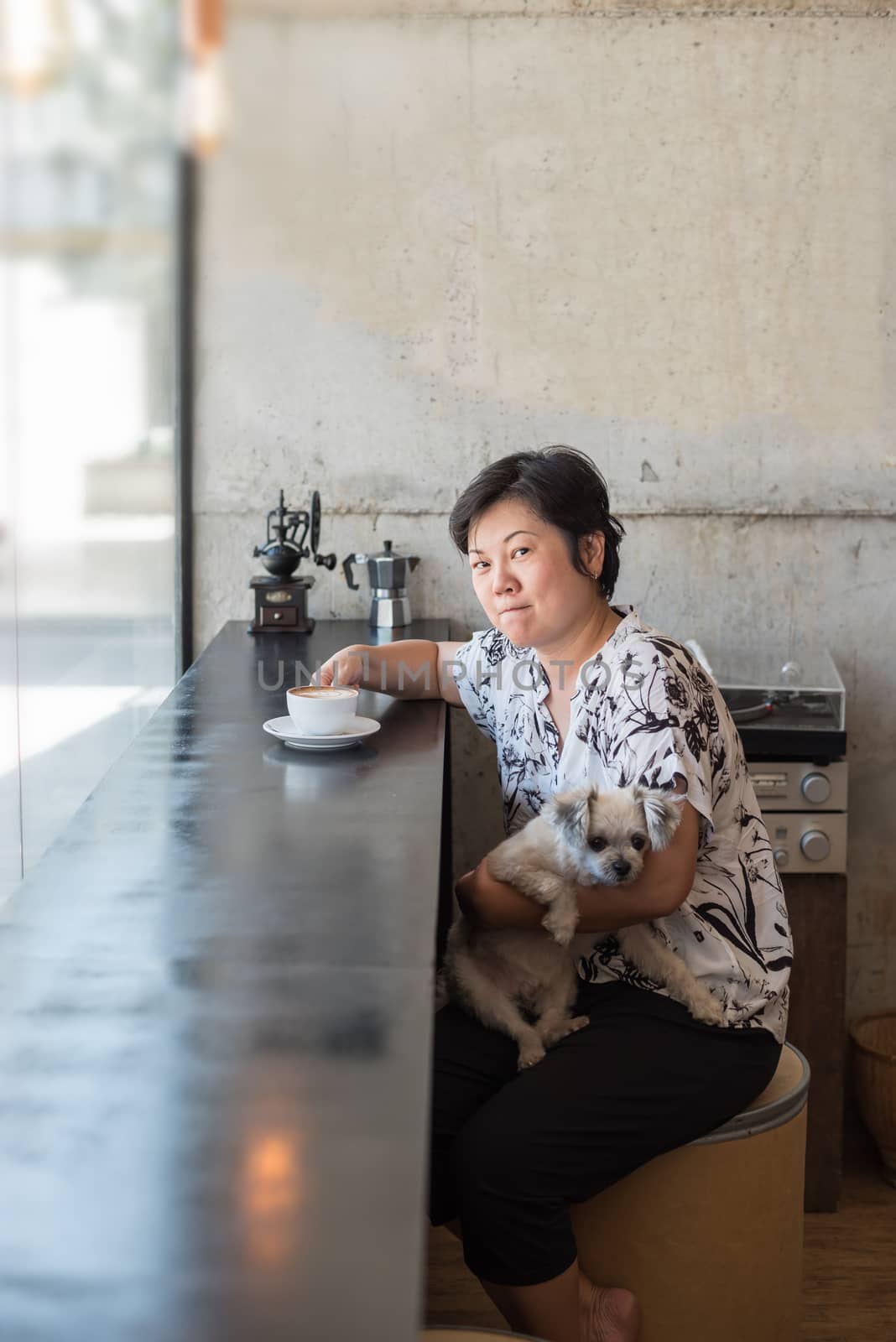Asian women and dog in coffee shop cafe by PongMoji