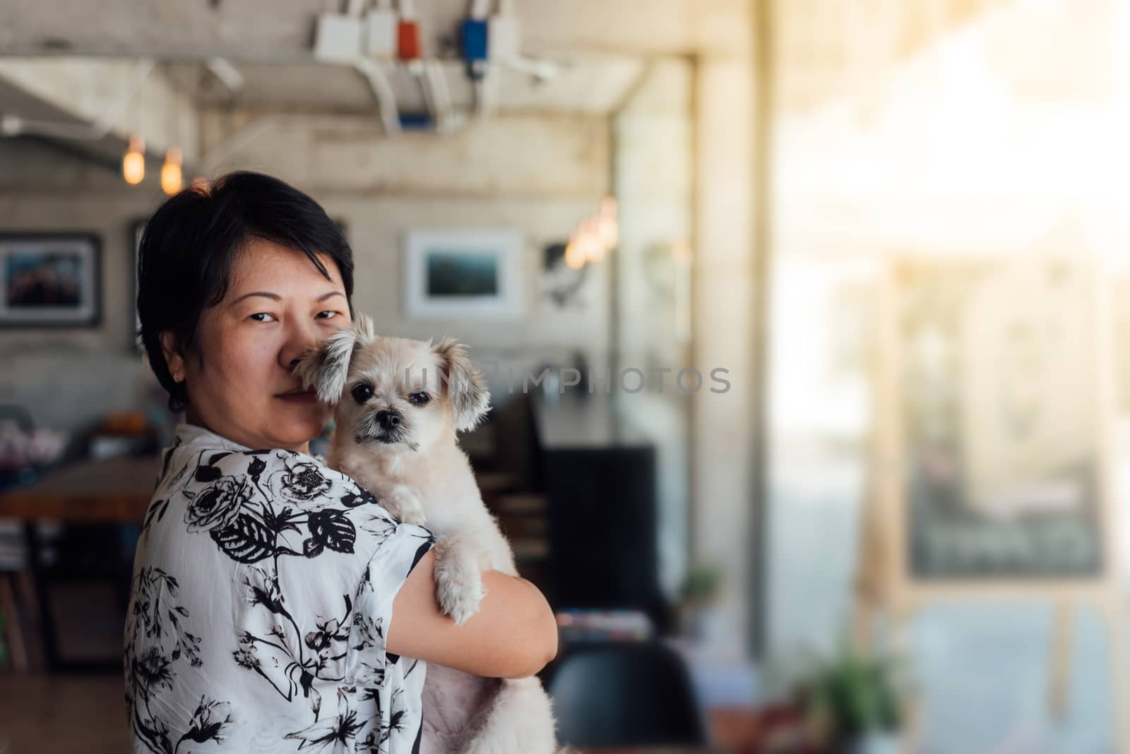 Asian woman and dog in coffee shop cafe by PongMoji