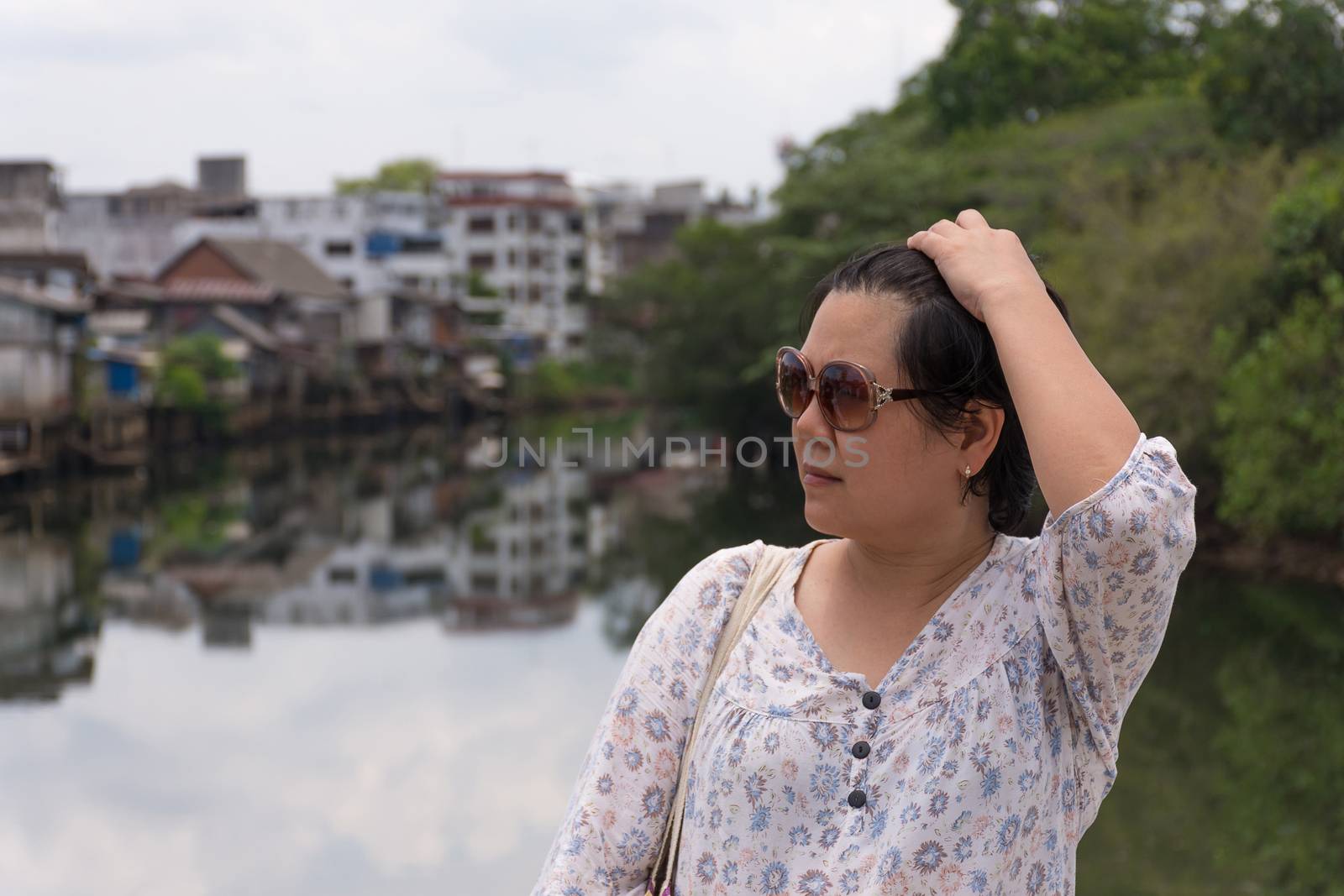 Asia woman plump body with sunglasses standing at river side when travel