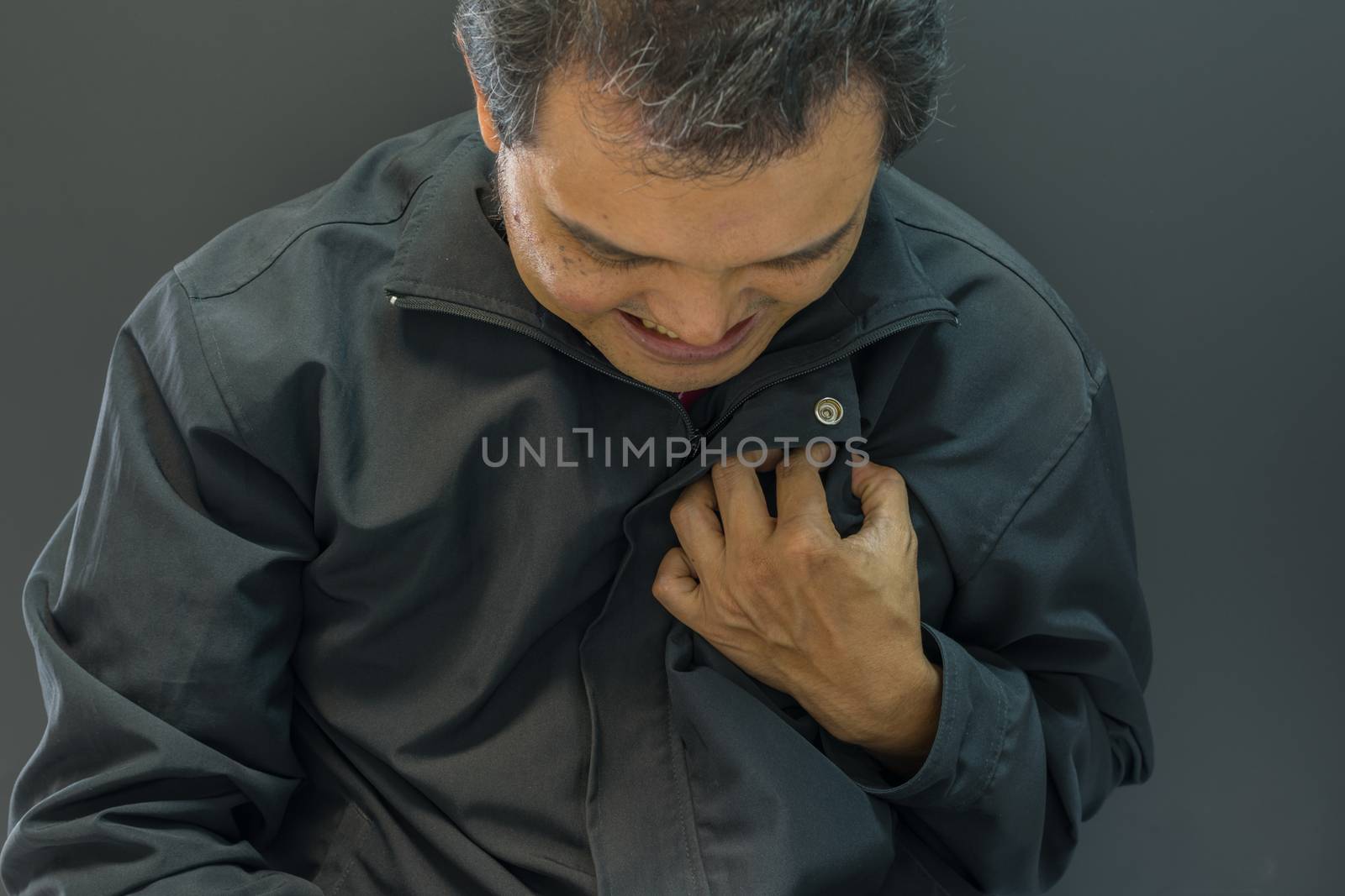 Asia man pain from disease heart attack in black background