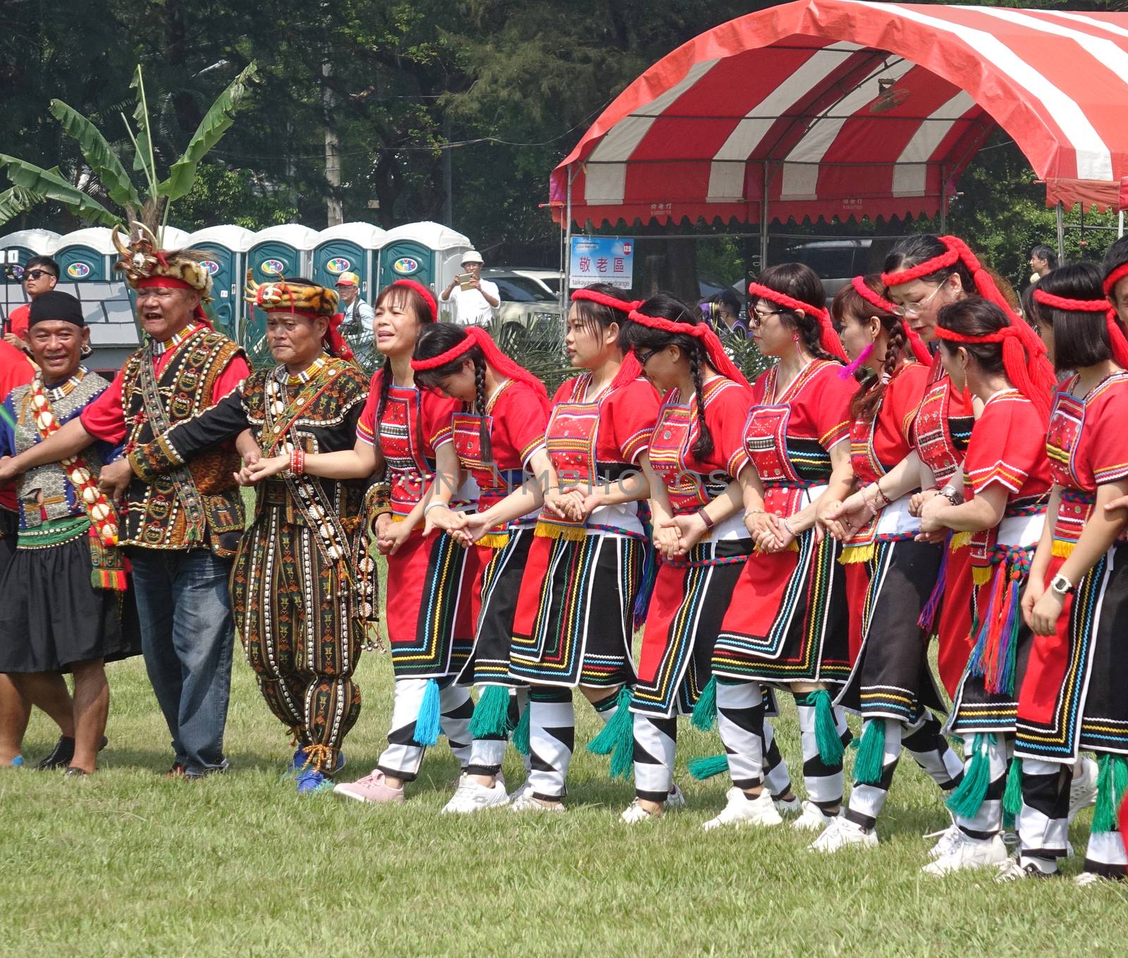 KAOHSIUNG, TAIWAN -- SEPTEMBER 28, 2019: Men and women of the indigenous Rukai tribe perform a dance during the traditional harvest festival.