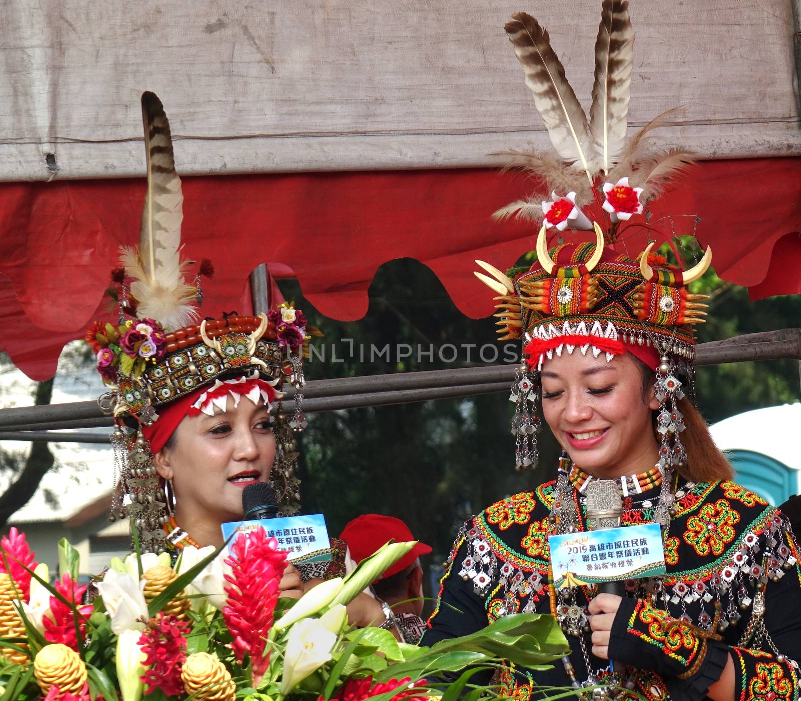 KAOHSIUNG, TAIWAN -- SEPTEMBER 28, 2019: Two young women of the indigenous Rukai tribe introduce the traditional harvest festival.
