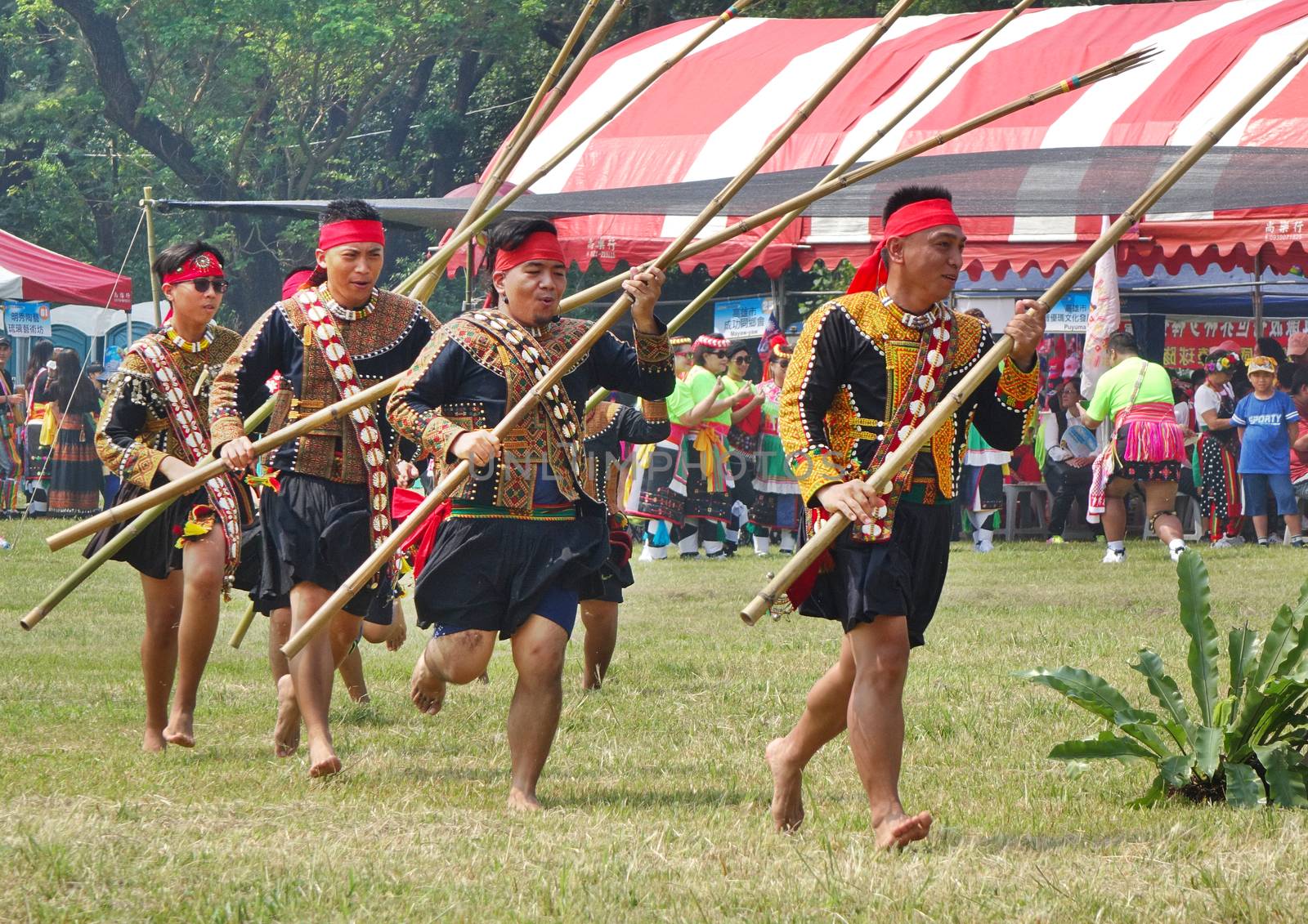 KAOHSIUNG, TAIWAN -- SEPTEMBER 28, 2019: Men with bamboo spears of the indigenous Rukai tribe perform a dance during the traditional harvest festival.
