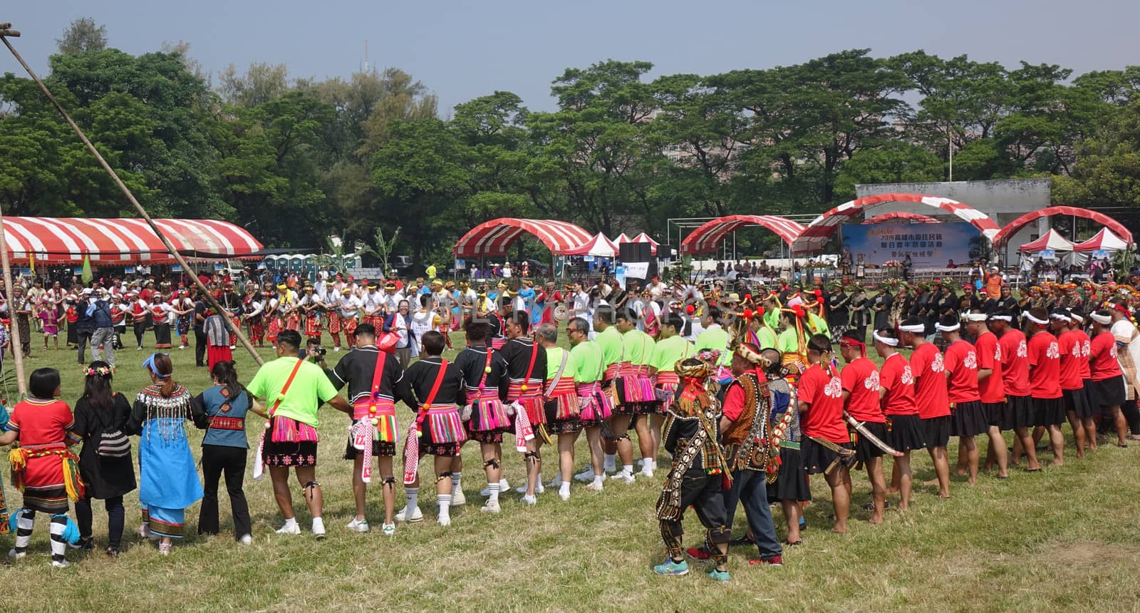 KAOHSIUNG, TAIWAN -- SEPTEMBER 28, 2019: Various indigenous tribes dance in a large circle during the traditional harvest festival.