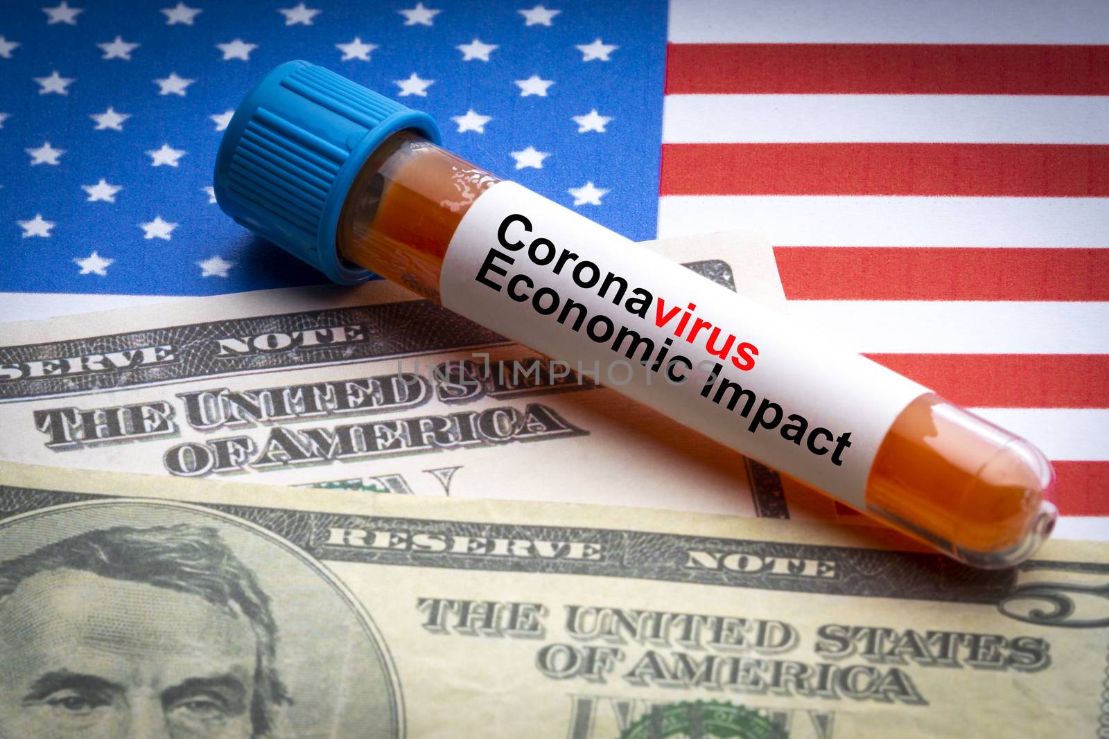 CORONAVIRUS ECONOMIC IMPACT text, US Dollar and blood sample vacuum tube on America flags background. Covid-19 or Coronavirus Concept 