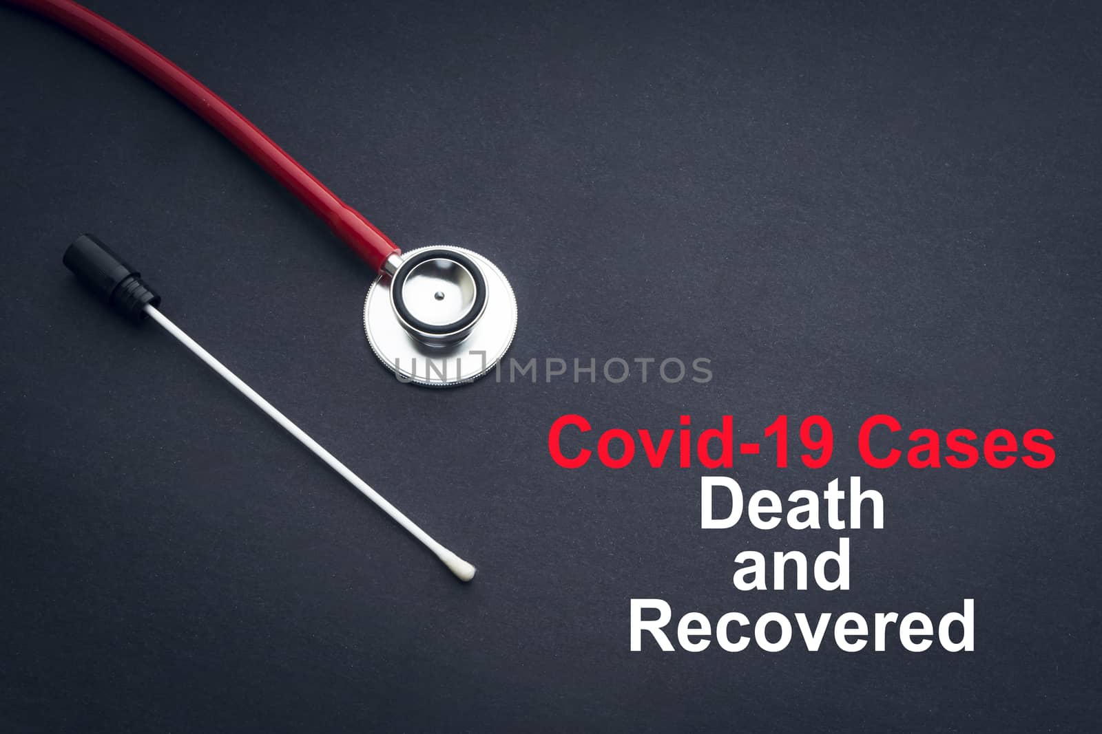 COVID-19 or CORONAVIRUS DEATH AND RECOVERED text with stethoscope and medical swab on black background by silverwings
