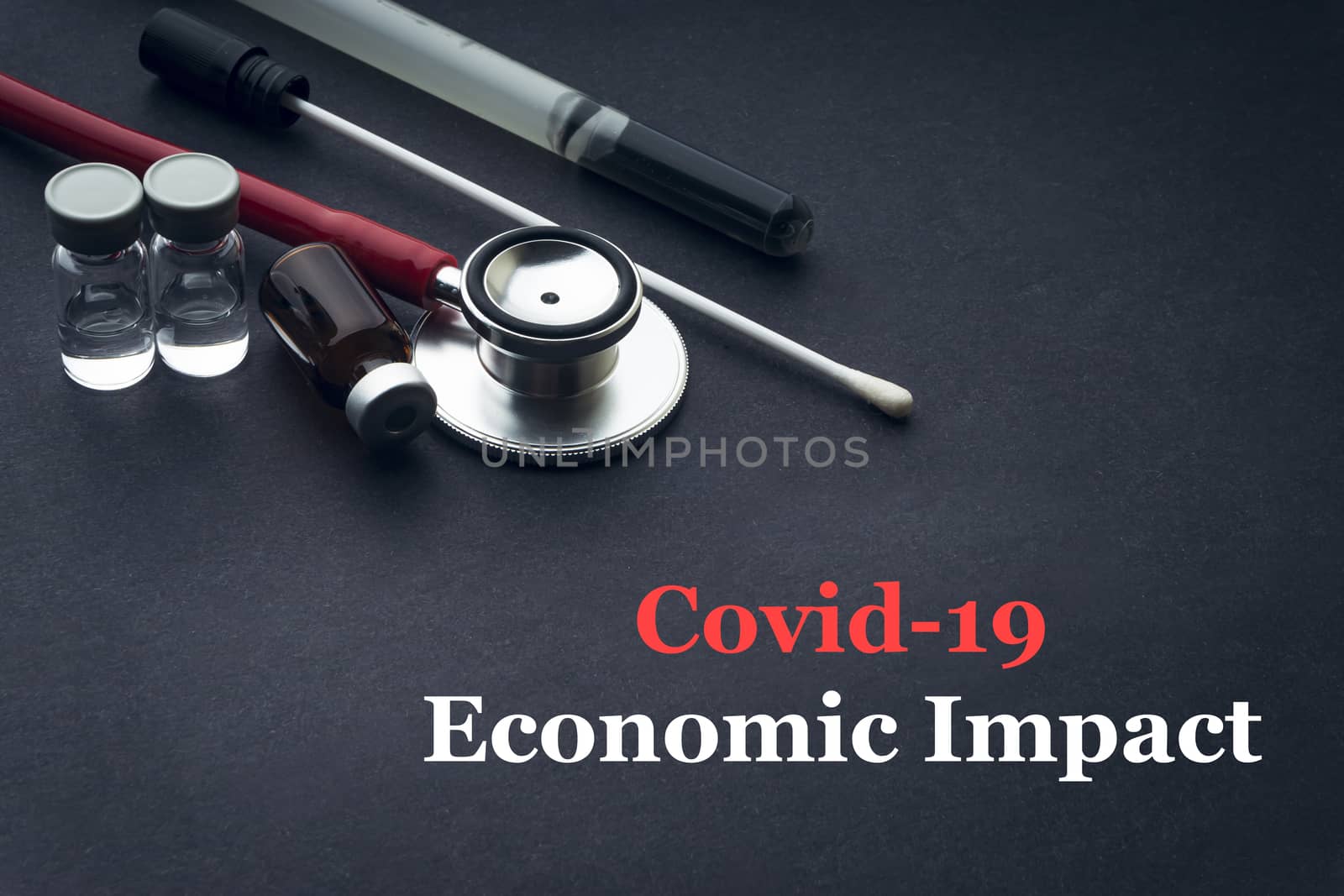 COVID-19 or CORONAVIRUS ECONOMIC IMPACT text with stethoscope, medical swab and vial on black background. Covid-19 or Coronavirus concept. 