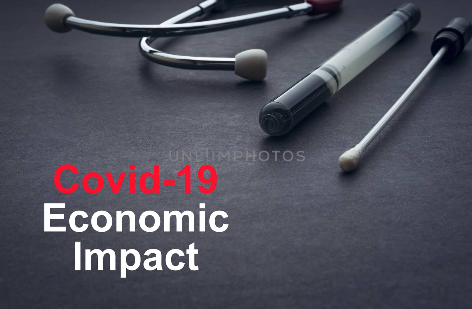 COVID-19 or CORONAVIRUS ECONOMIC IMPACT text with stethoscope and medical swab on black background by silverwings