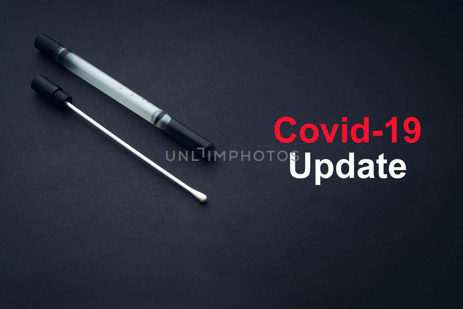 COVID-19 or CORONAVIRUS UPDATE text with medical swab on black background by silverwings