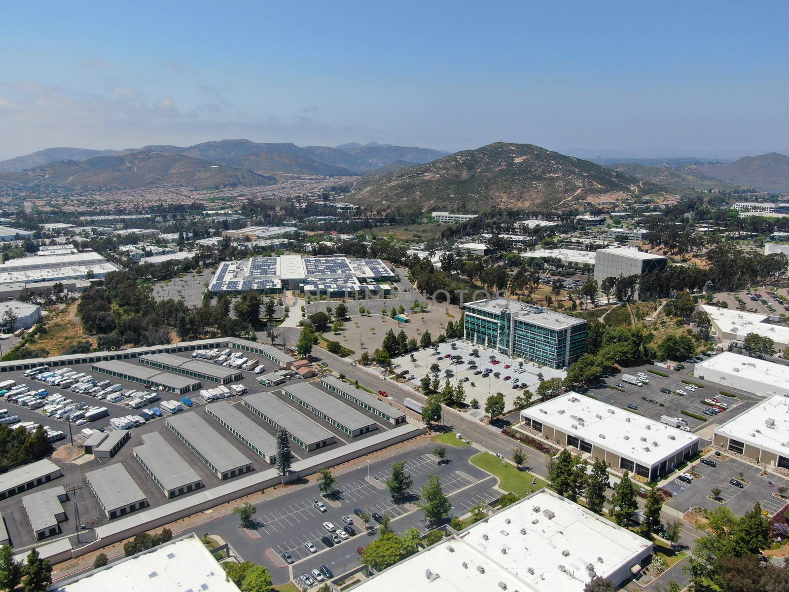 Aerial view to industrial zone and company office, storage warehouse, California by Bonandbon