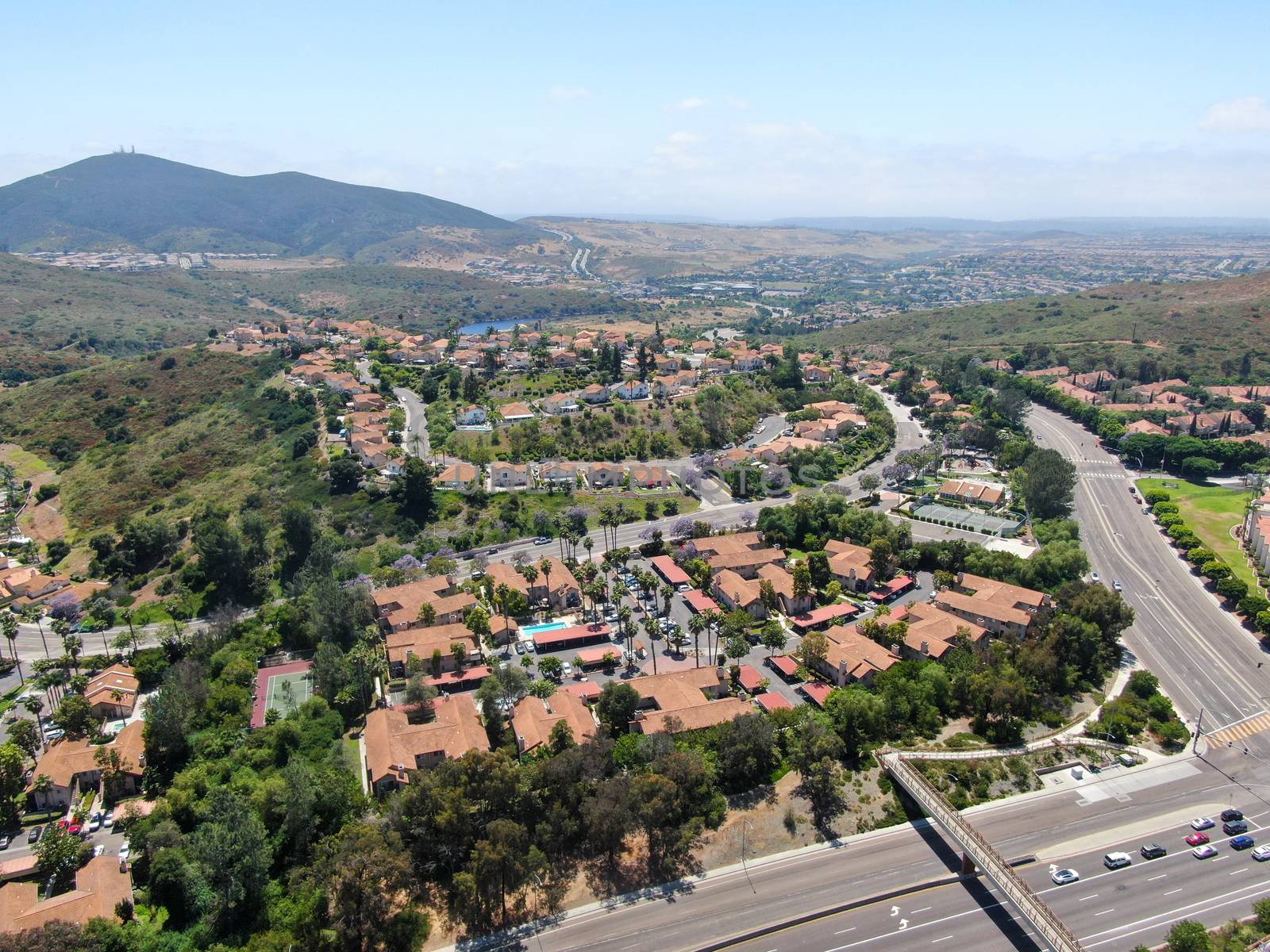 Aerial view middle class neighborhood with condo community and residential house and mountain on the background in Rancho Bernardo, South California, USA.