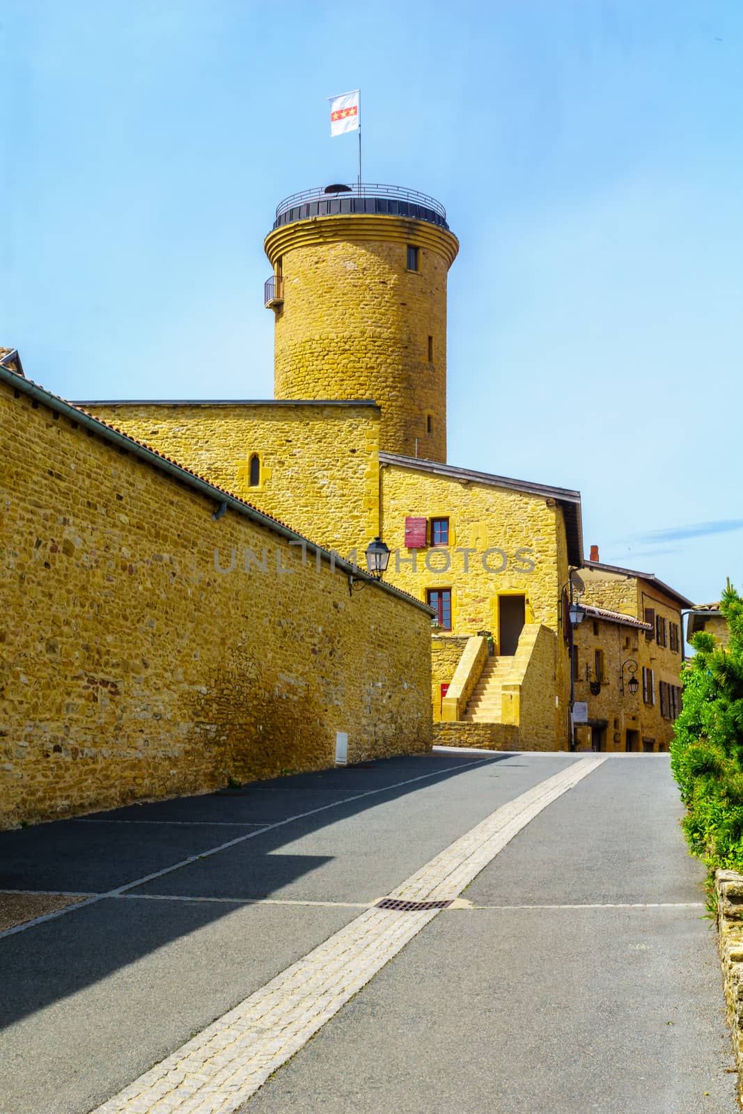 Street in the medieval village Oingt, and the keep tower, in Beaujolais, Rhone department, France