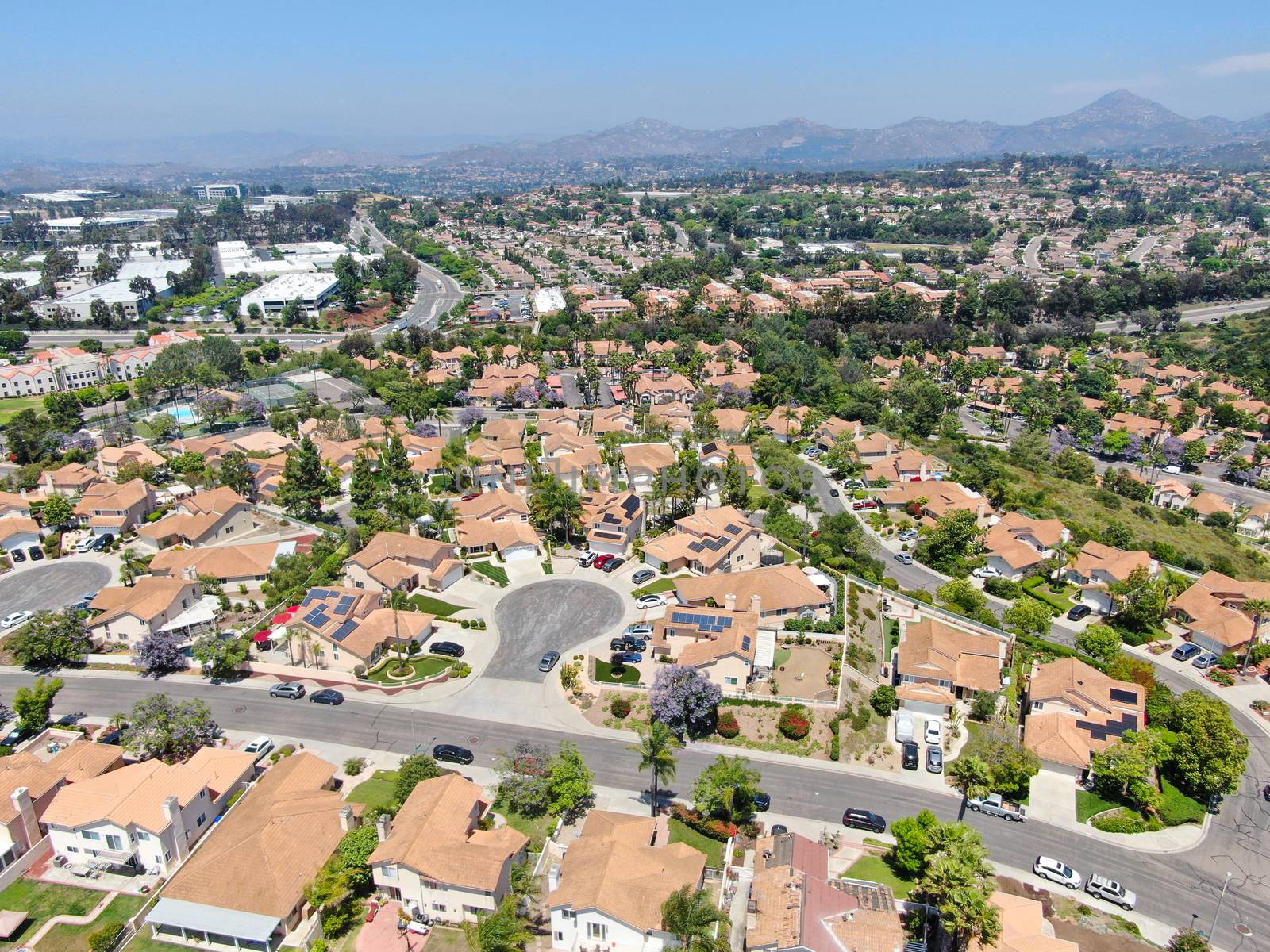 Aerial view of middle class neighborhood street with residential house by Bonandbon