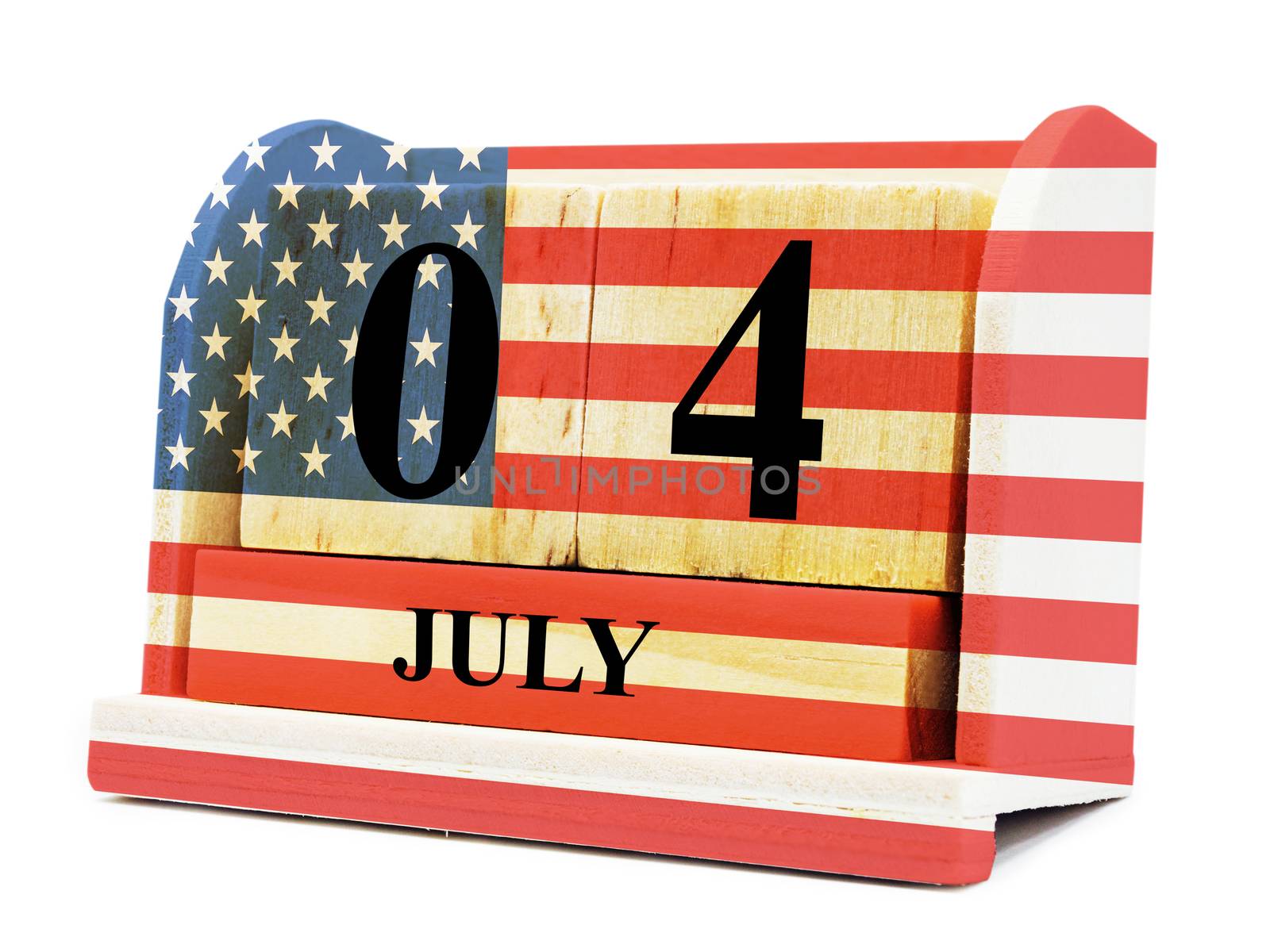 Cube shape calendar for July 04 on wooden surface with USA flag isolated with clipping path