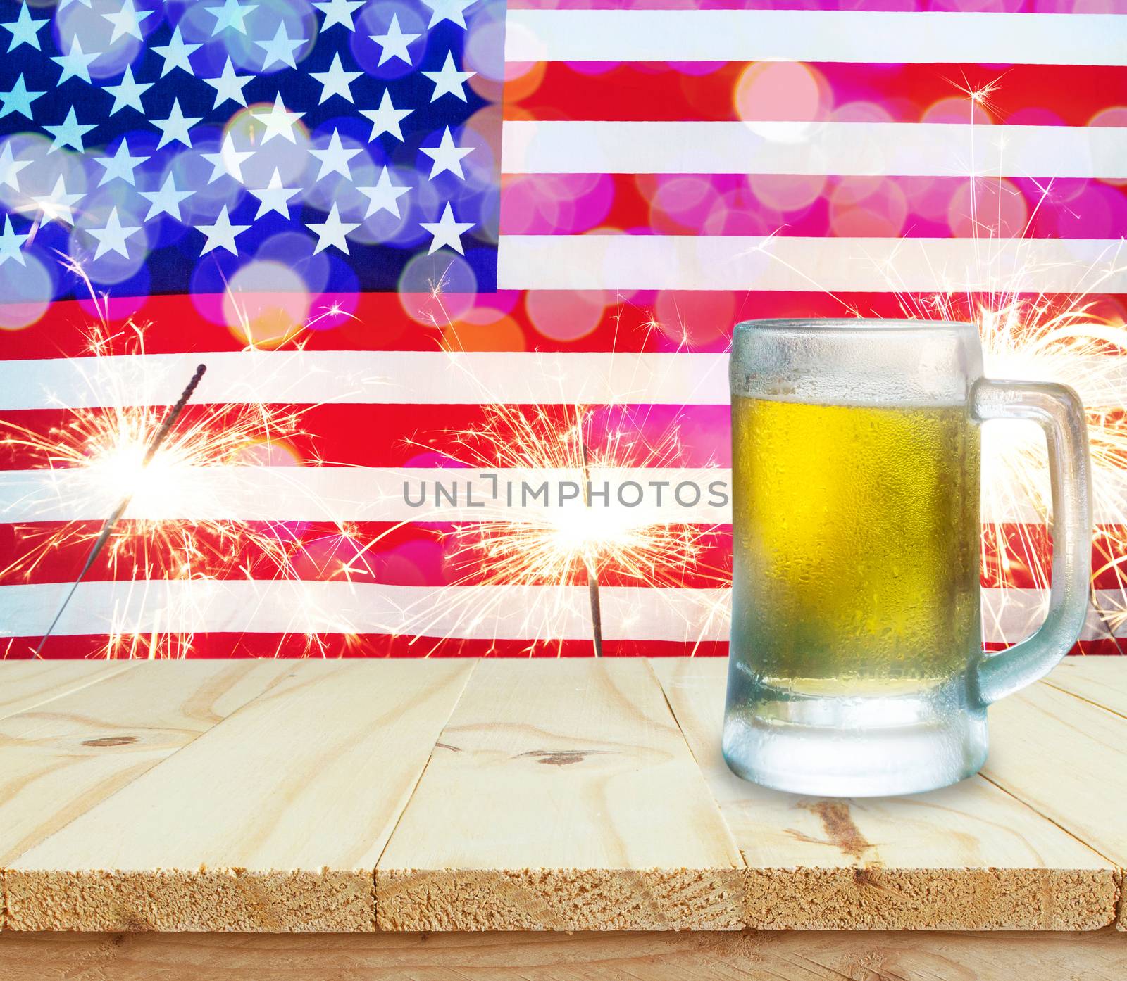 Glass of beer on wooden table. USA flag with sparklers background celebrate American Independence Day of 4th July