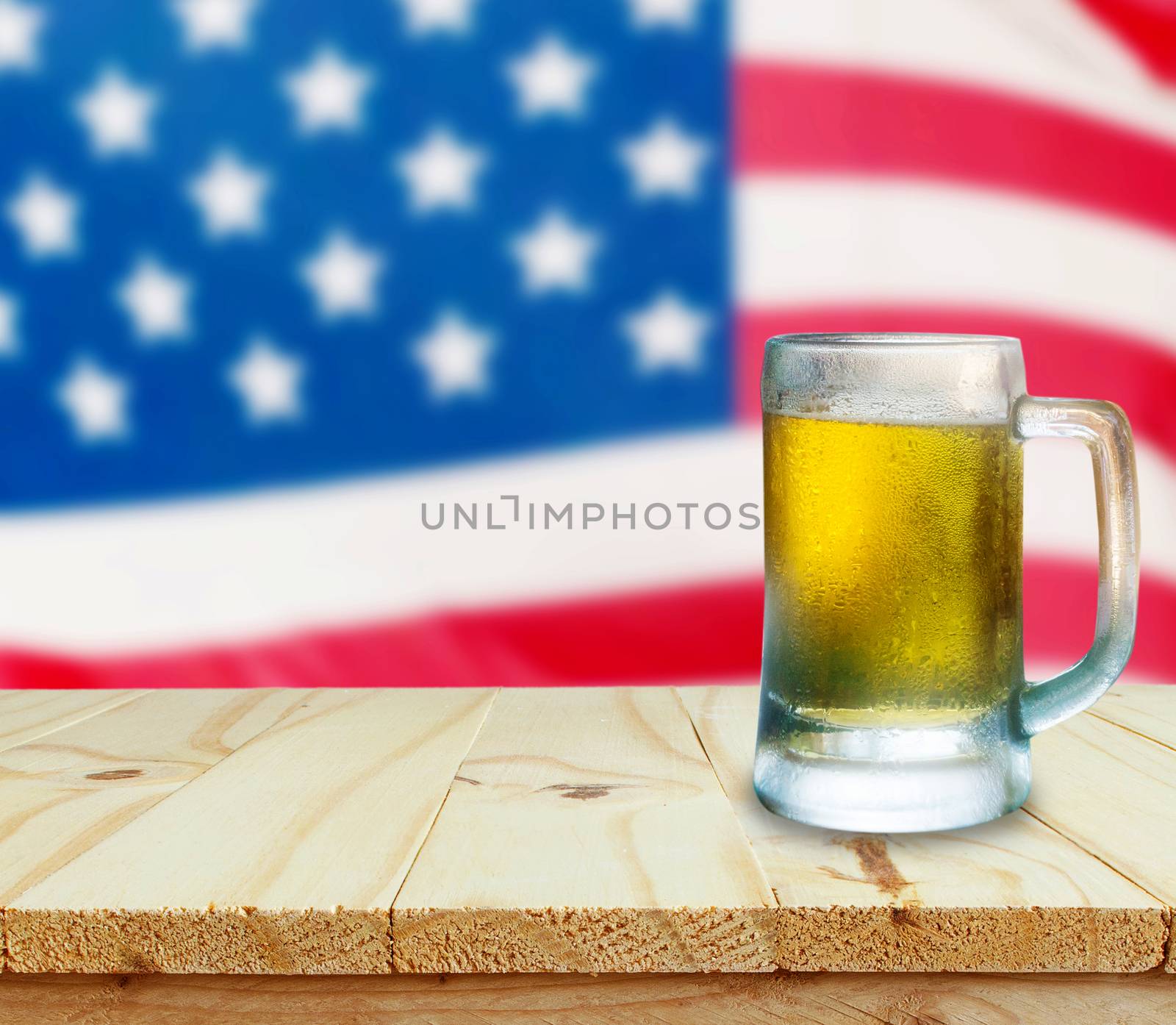 Glass of beer on wooden table. USA flag background celebrate American Independence Day of 4th July