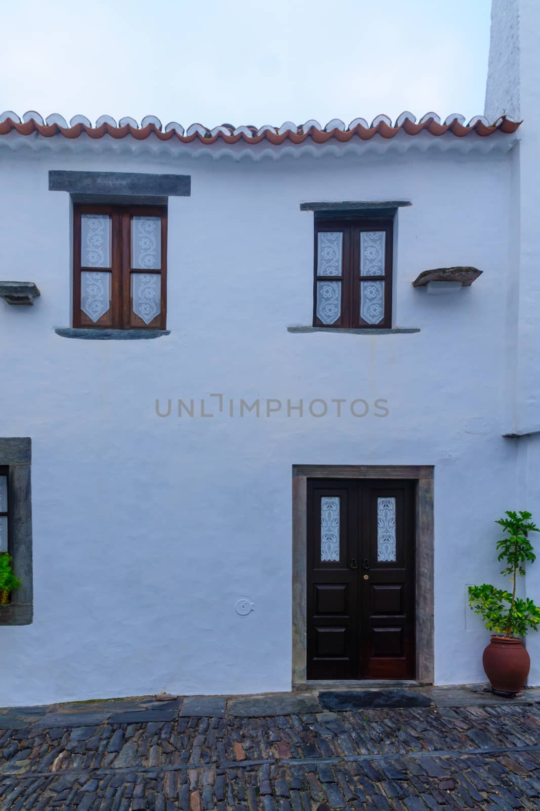 Typical house wall with door and windows, in the historic village of Monsaraz, Portugal