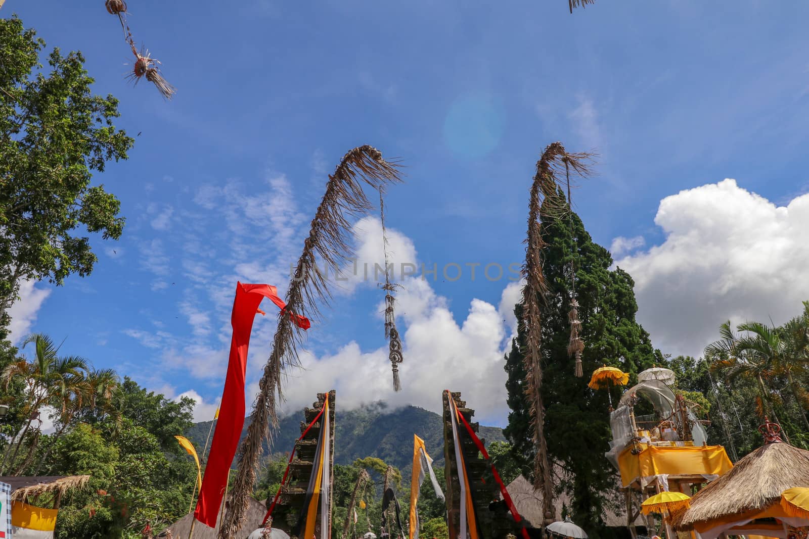 Entrance gate to Hindu sacred temple Pura Luhur Batukaru with decorative reliefs and mountain scene. Grand gate in the Hindu temple of Batukaru with a view of the mountain top.