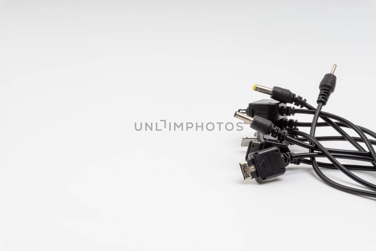 Universal recharger head or usb cable isolated on white background. Selective focus and crop fragment