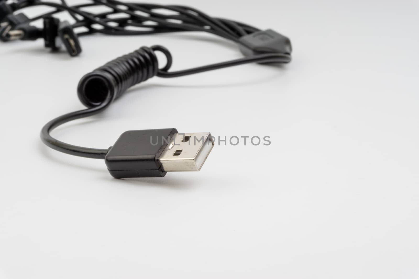 Universal recharger head or usb cable isolated on white background. Selective focus and crop fragment