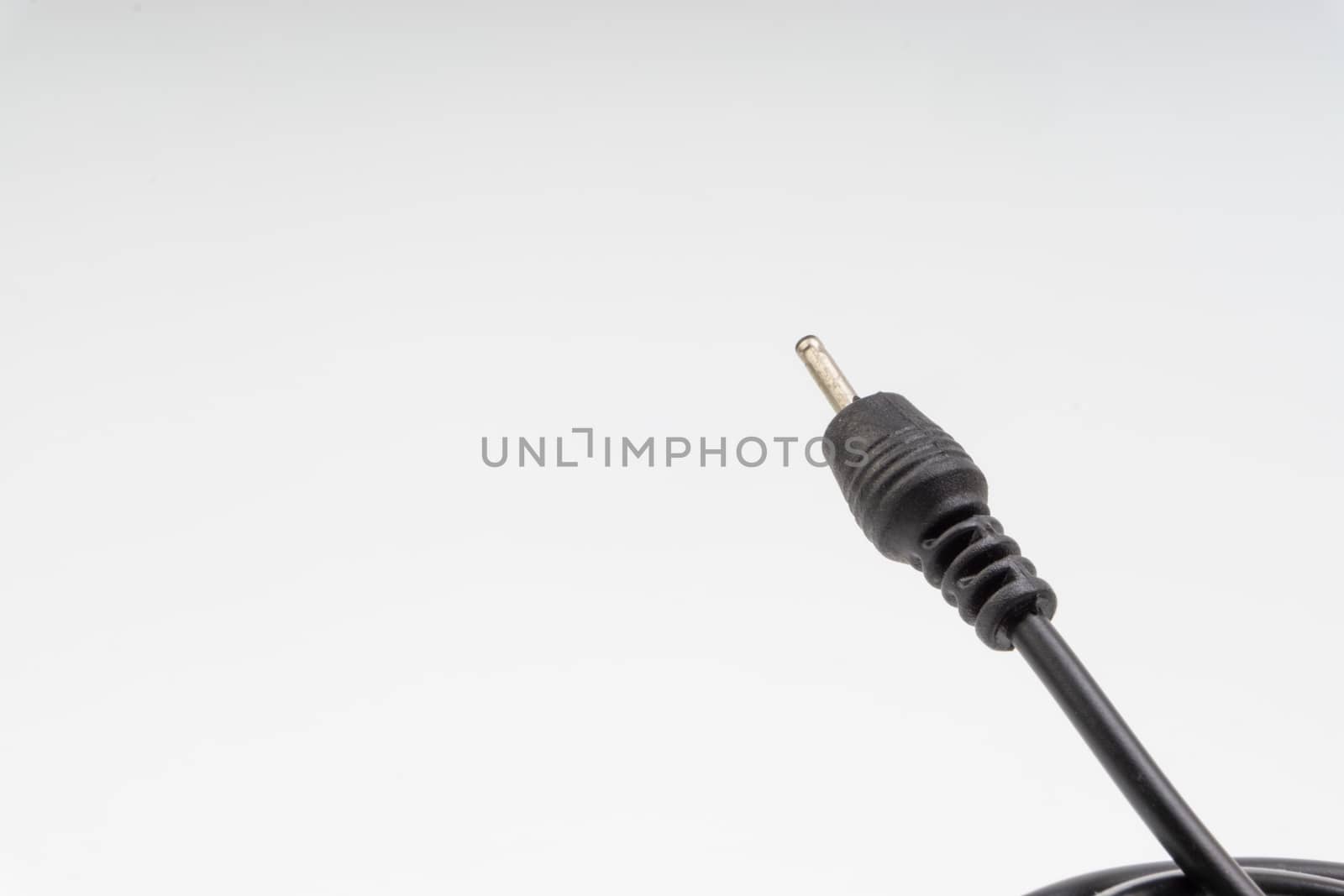 Universal recharger head or usb cable isolated on white background. Selective focus and crop fragment