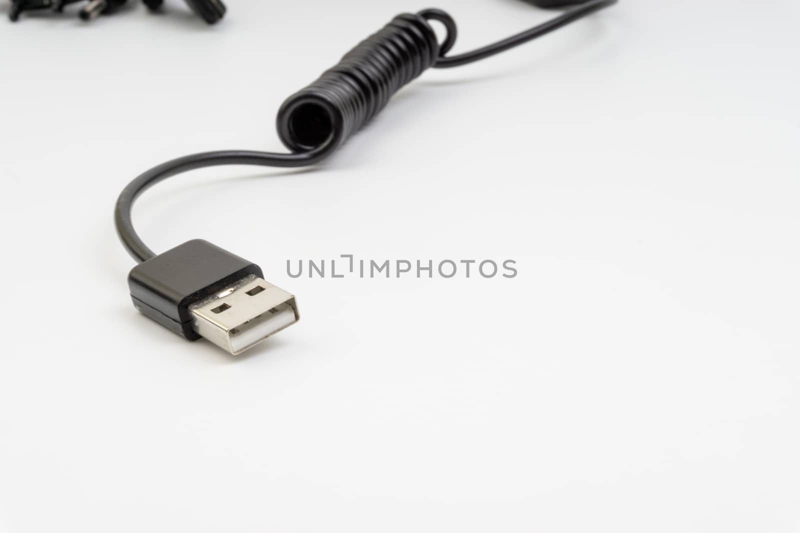 Universal recharger head or usb cable isolated on white background. Selective focus and crop fragment