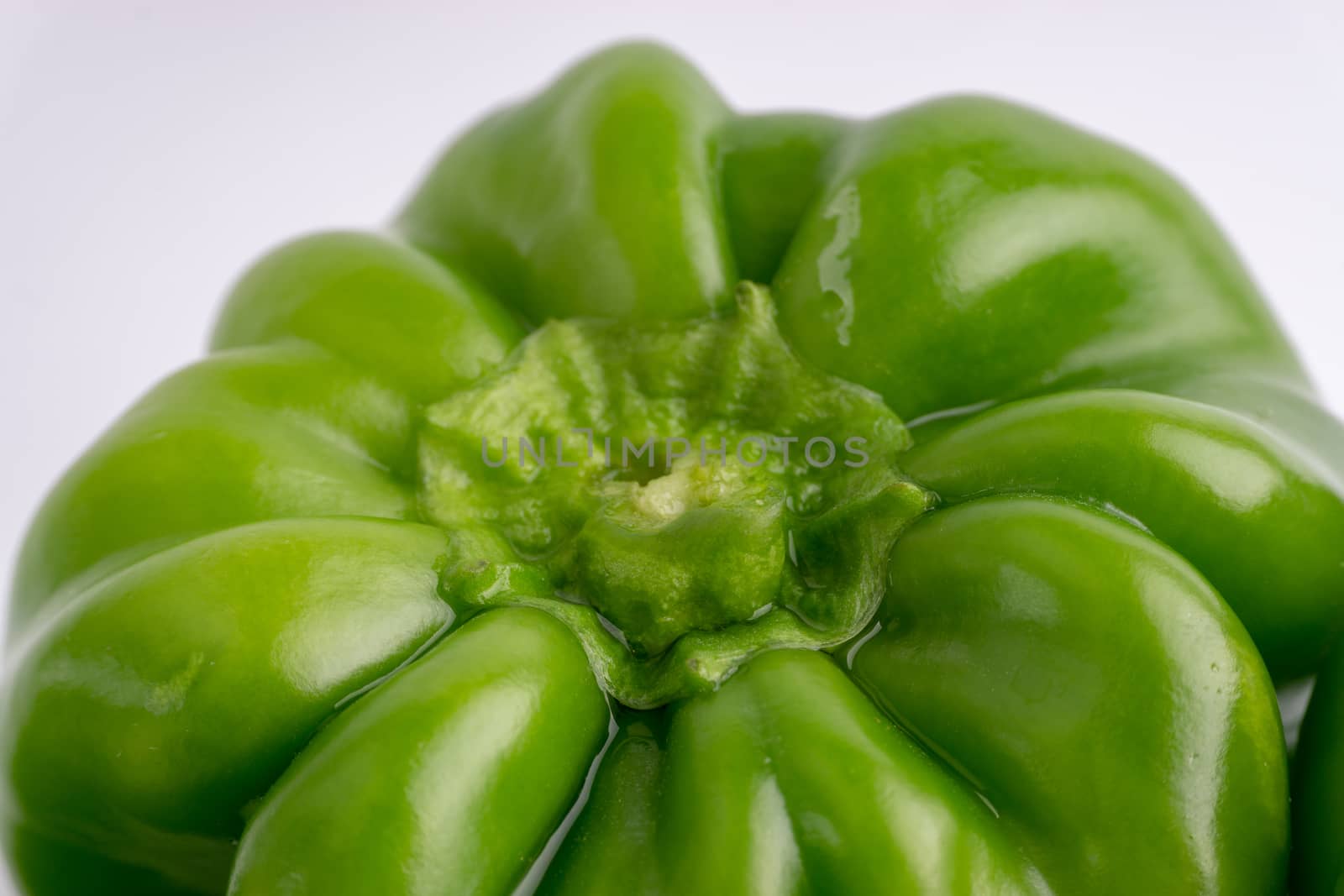 Fresh green bell peppers (capsicum) on a white background by silverwings