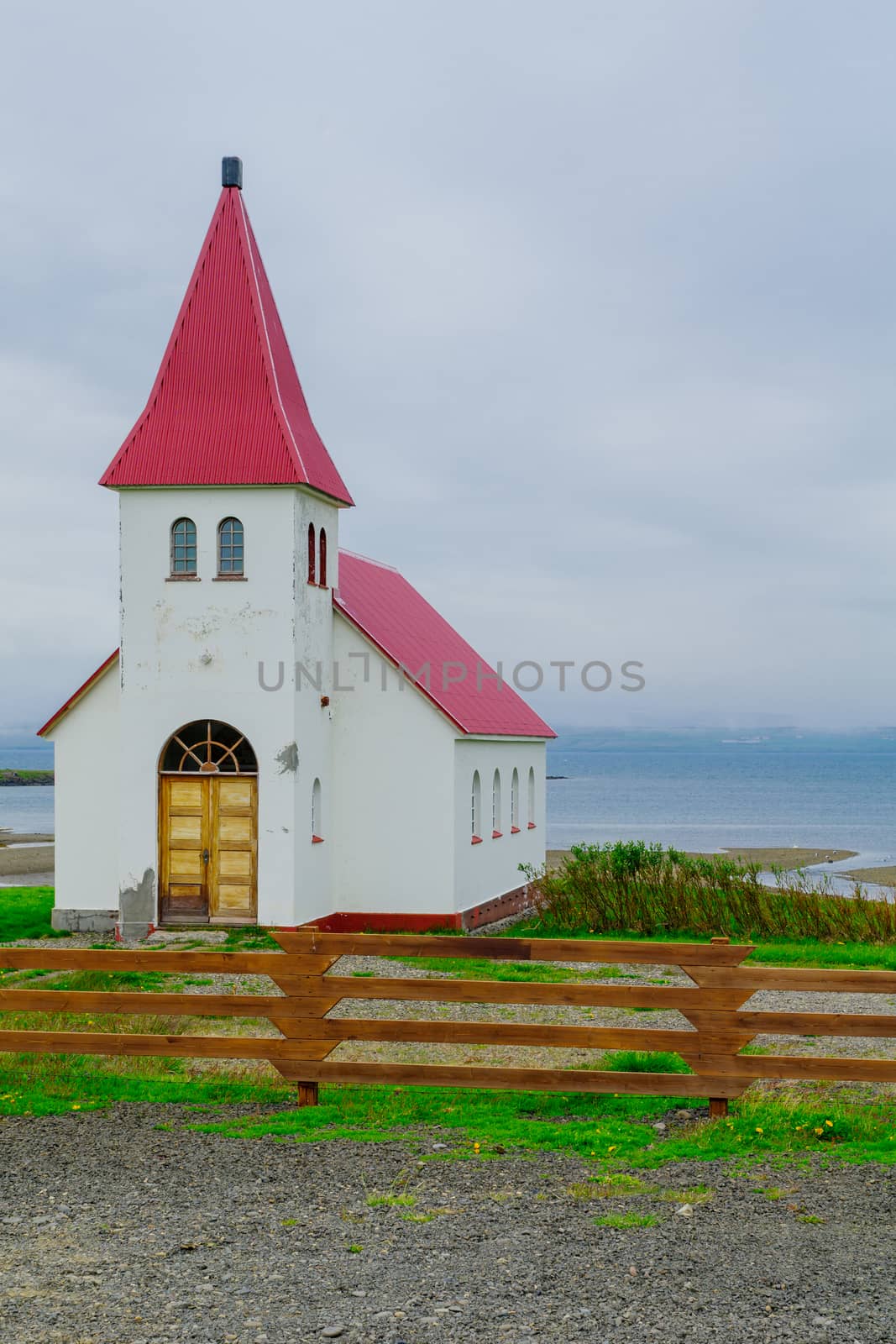Countryside and a secluded church along the Hrutafjordur fjord, in the west fjords region, Iceland