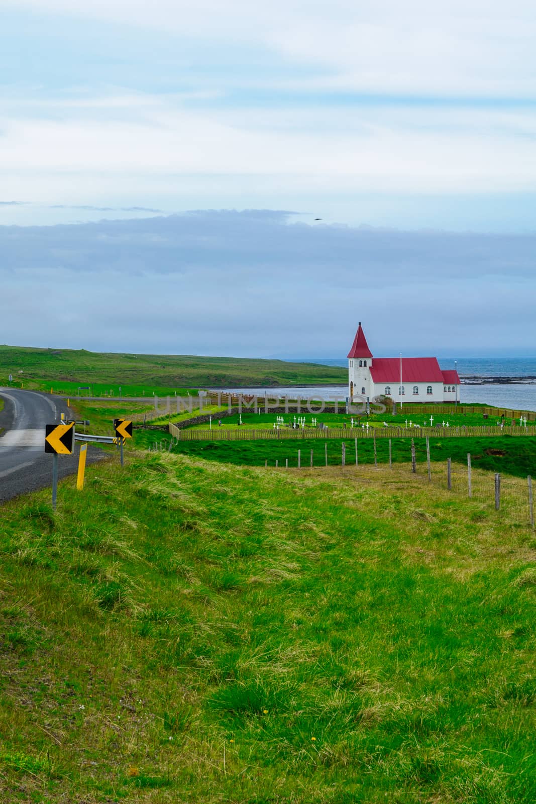 Countryside and a secluded church along the Hrutafjordur fjord, in the west fjords region, Iceland