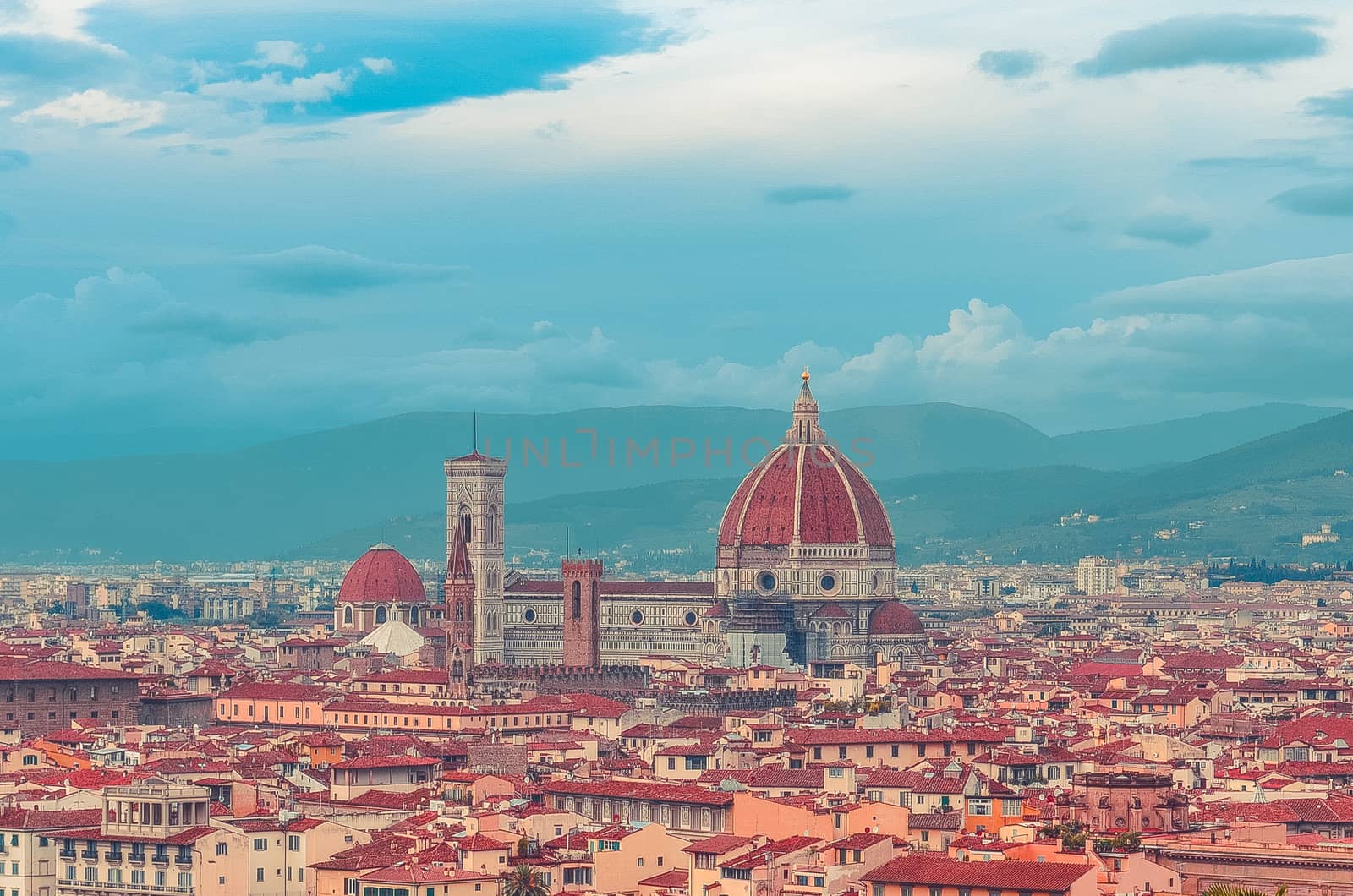 View of red roofs of Florence with Cattedrale di Santa Maria del Fiore (Florence Cathedral) in the middle. Italy