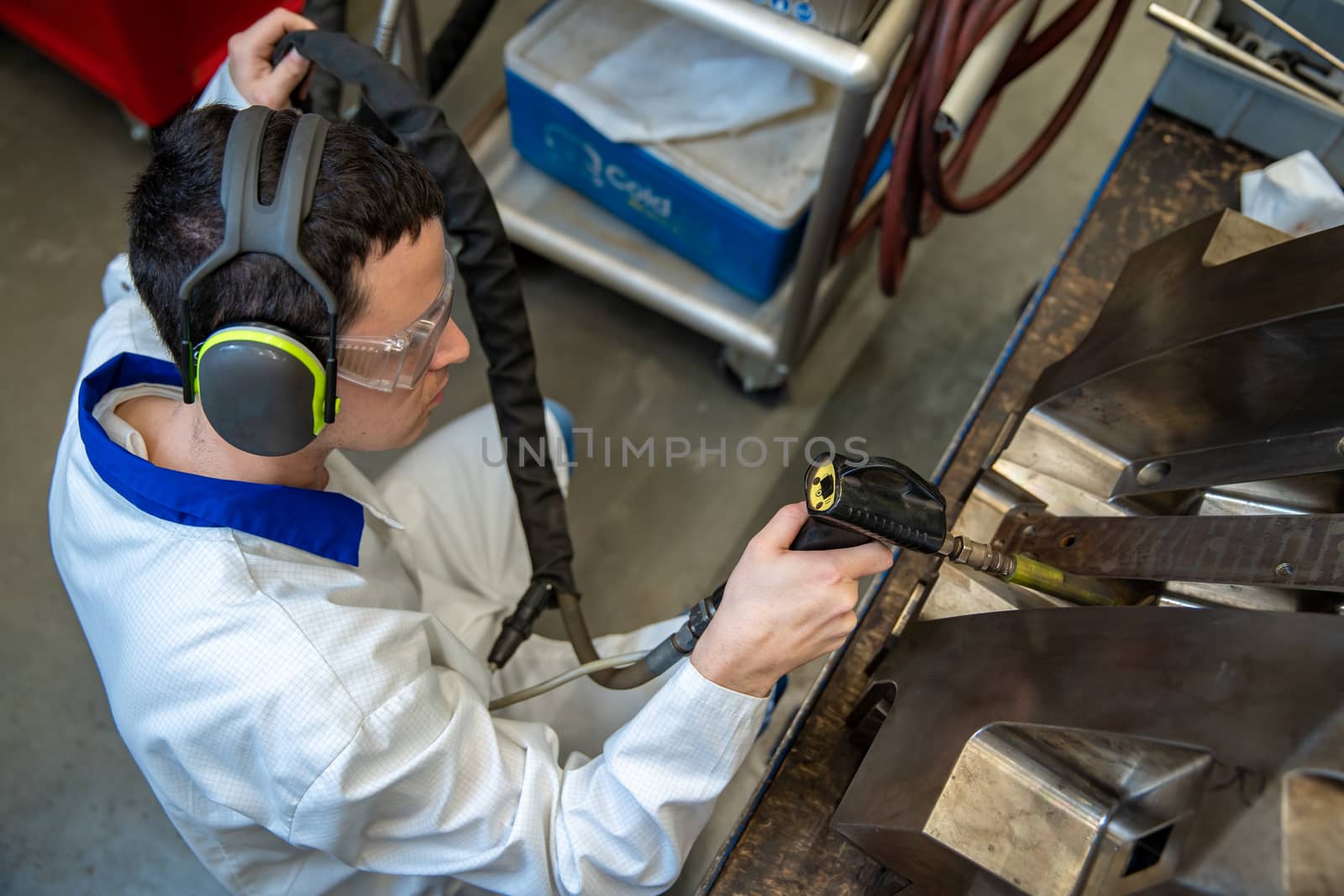 the engineer performs freezing of the casting using a special machine. maintenance of metal molds for plastic castings in the factory.