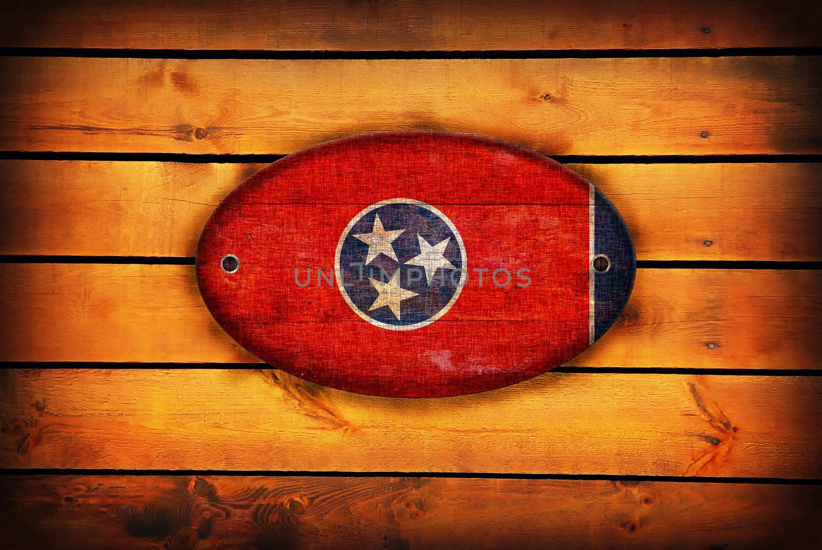 Tennessee flag on brown wooden planks.