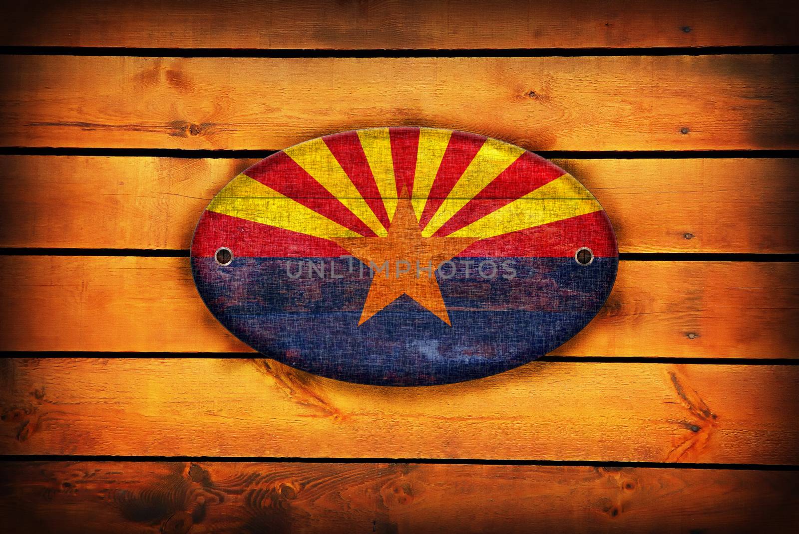 A Arizona flag on brown wooden planks.