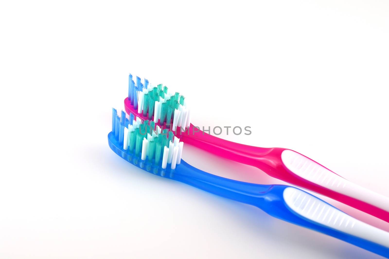 Two tooth-brushes over white by sergpet