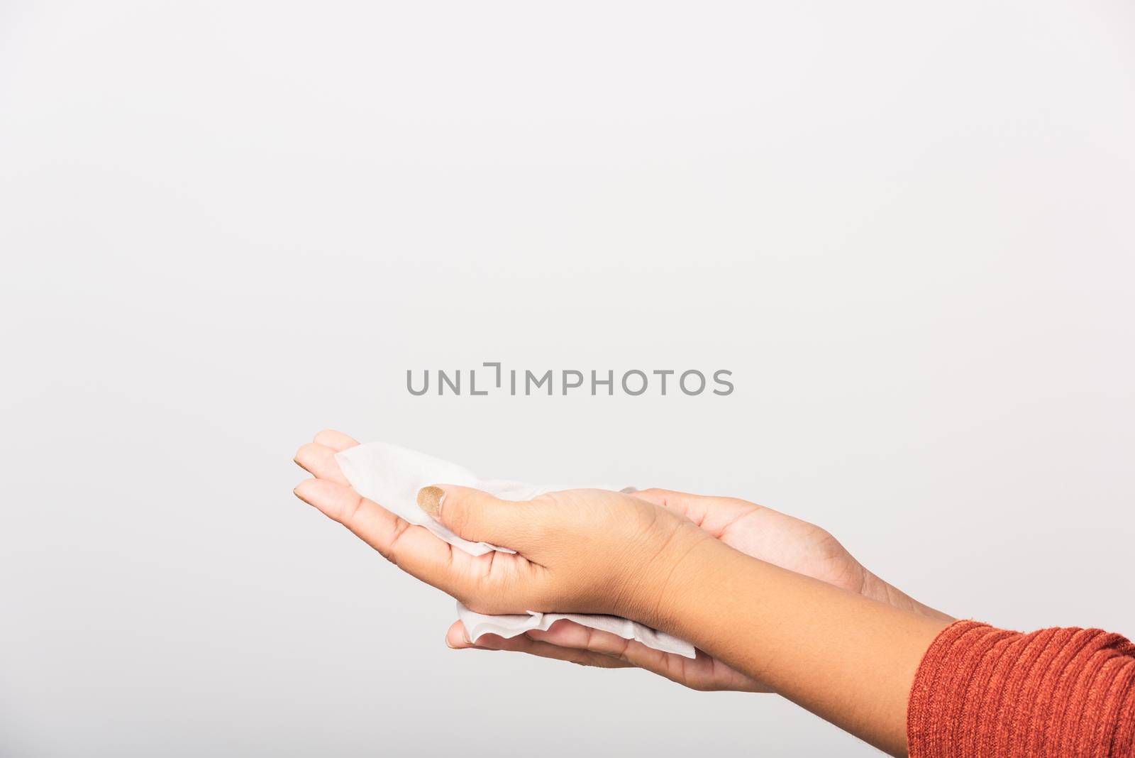woman she using wet tissue paper wipe cleaning her hands by Sorapop