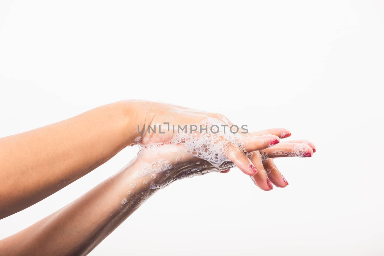 Closeup young Asian woman washing hands by soap for cleanliness and prevent germs coronavirus, studio shot isolated on white background, Healthcare medical COVID-19 virus concept