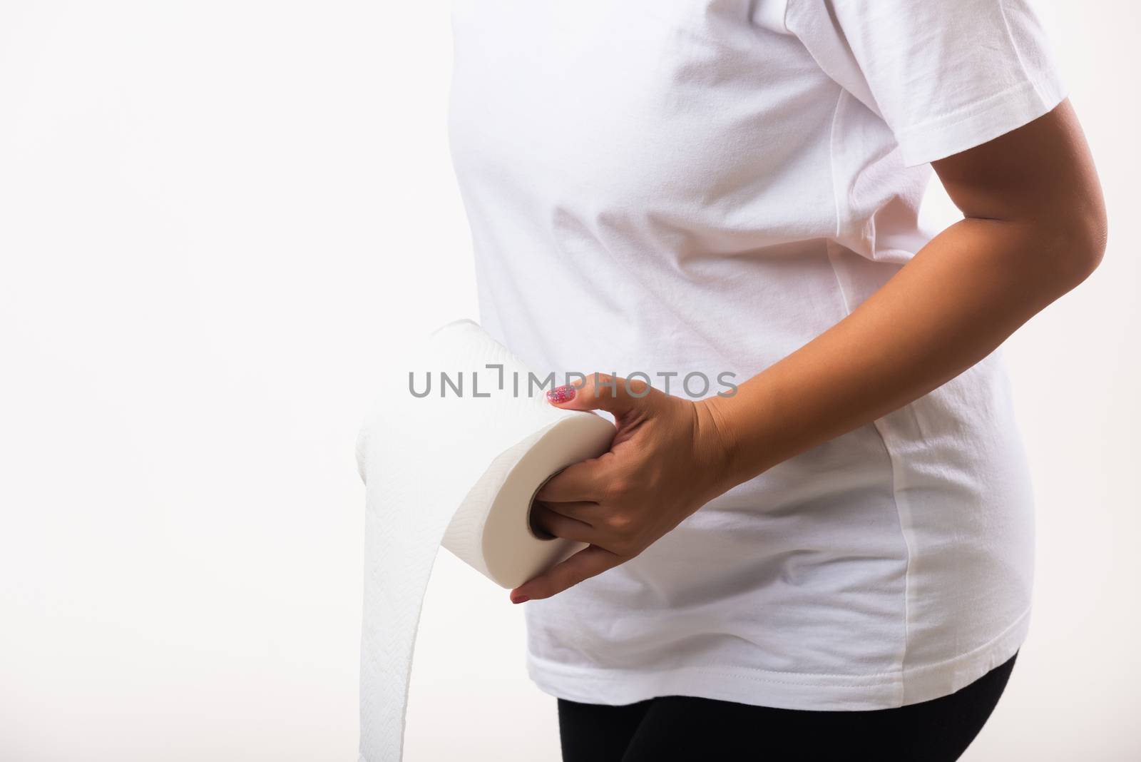 Closeup Asian young woman diarrhea constipation holding stomachache and tissue toilet paper roll on hand she crotch lower abdomen want to WC, studio shot isolated on white background, Health care