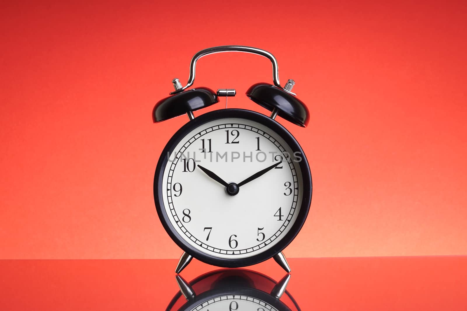 Alarm Clock on red background with selective focus by silverwings