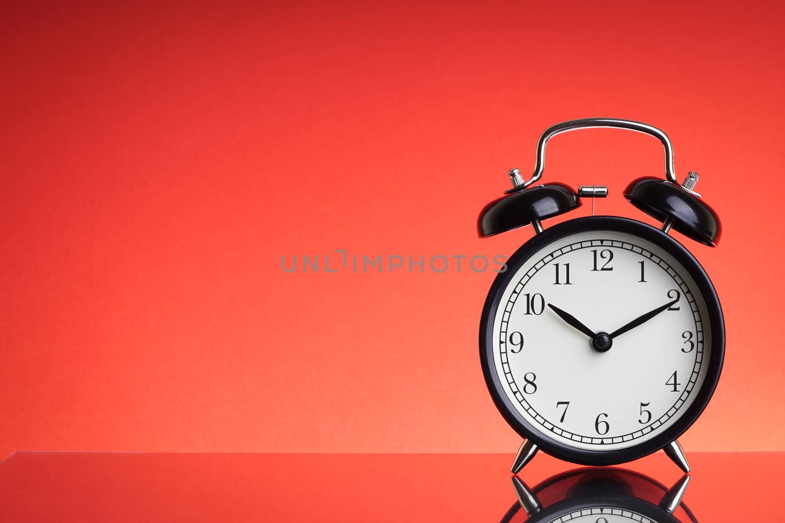 Alarm Clock on red background with selective focus and crop fragment. Business and Copy space concept