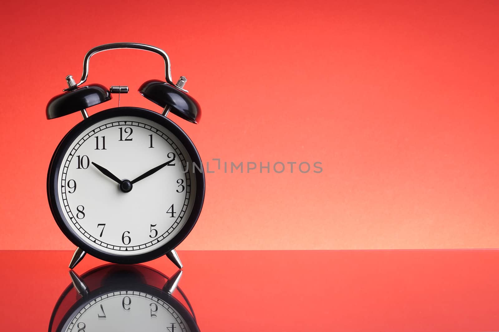 Alarm Clock on red background with selective focus by silverwings