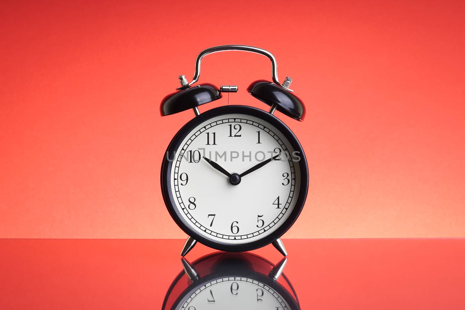 Alarm Clock on red background with selective focus and crop fragment. Business and Copy space concept