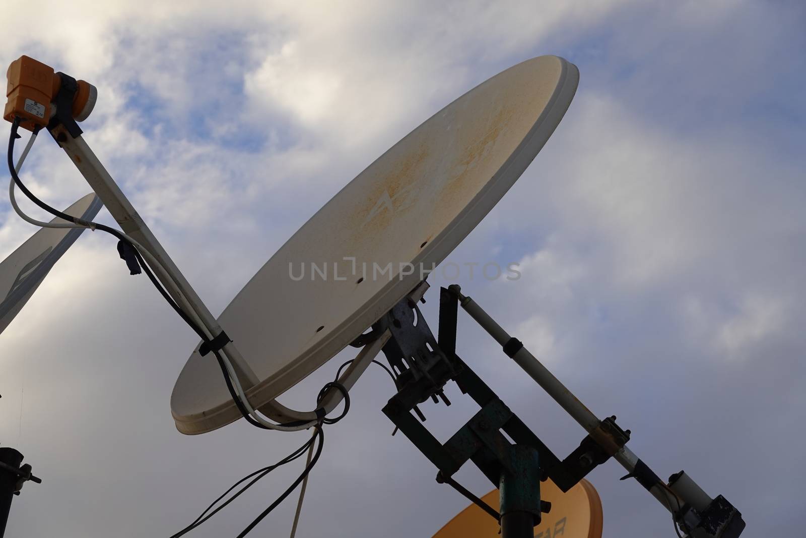 a satellite dish pointing to the blue sky.