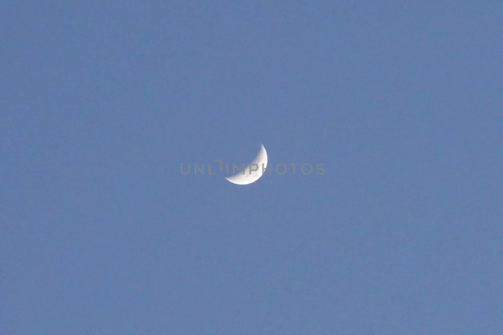 a small moon in the blue sky by devoxer