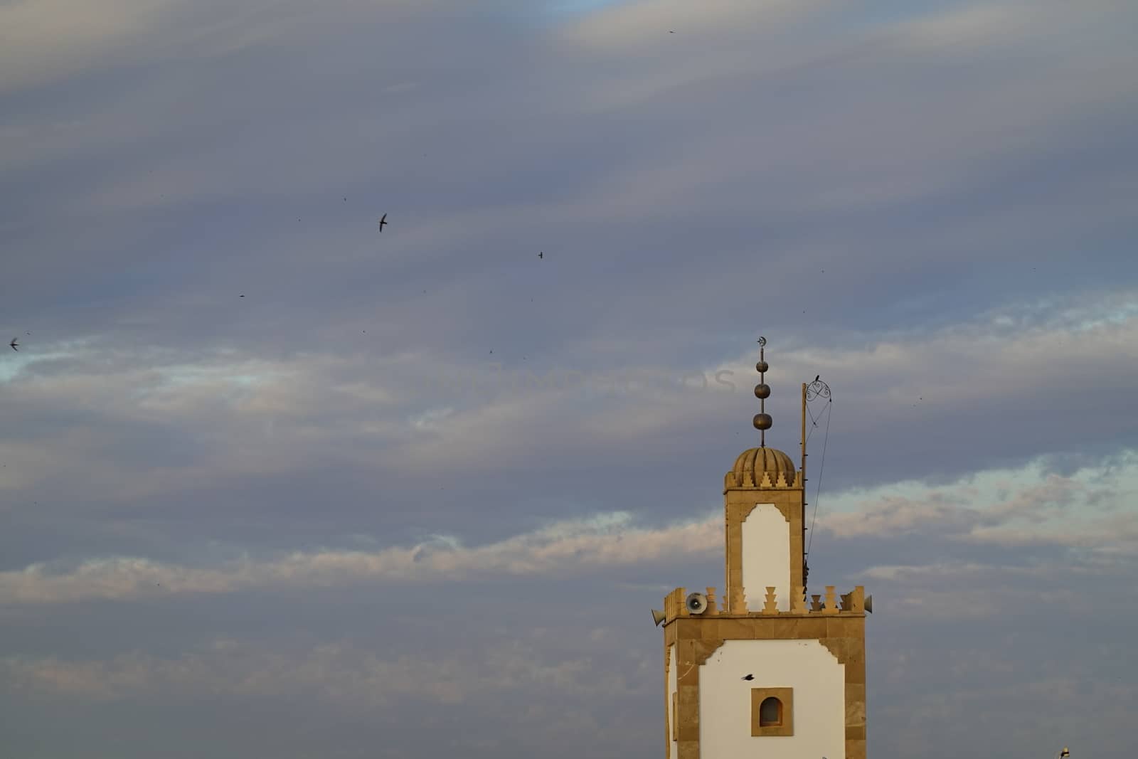 a mosk tower in a blue sky by devoxer