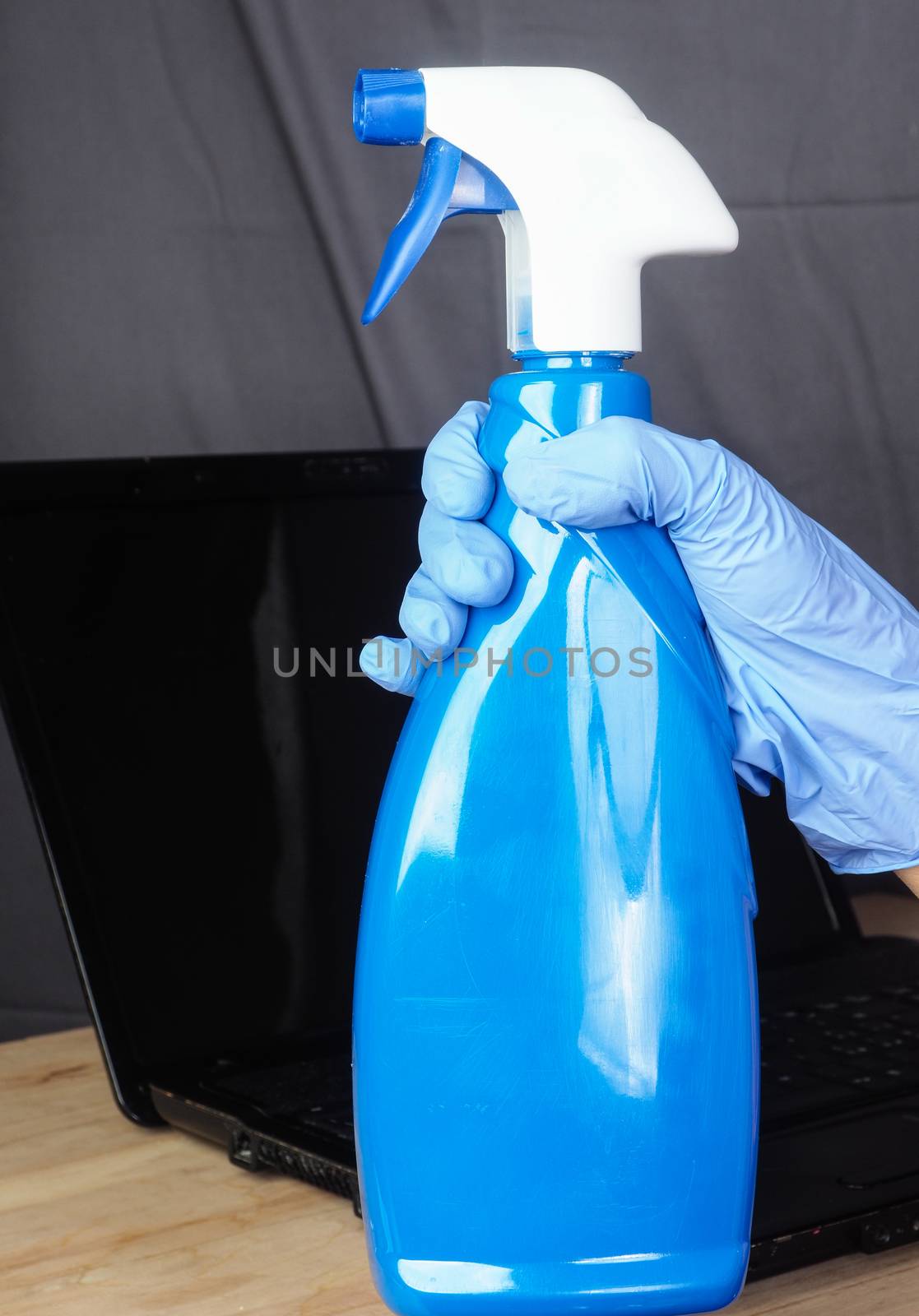 Hands of asian adult woman cleaning and sanitizing home office devices and objects to prevent corona covid-19 virus contagion infection