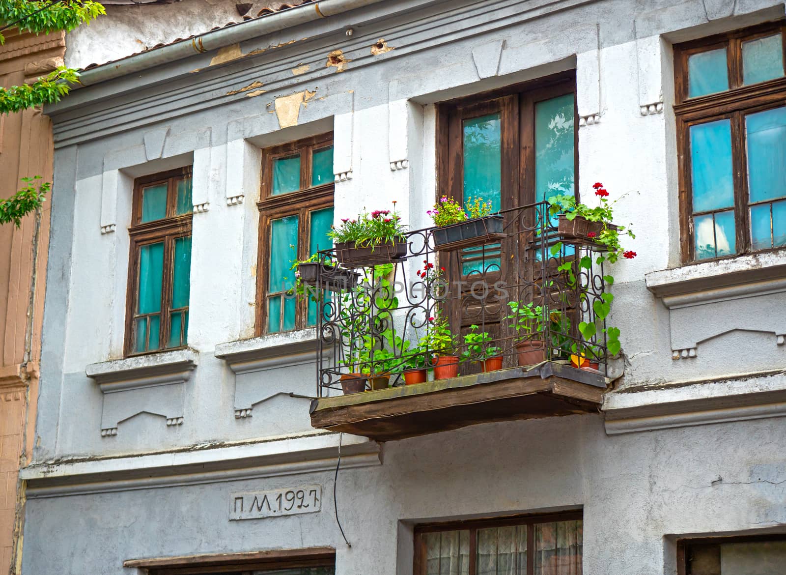 beautiful old house with balcony flower in city